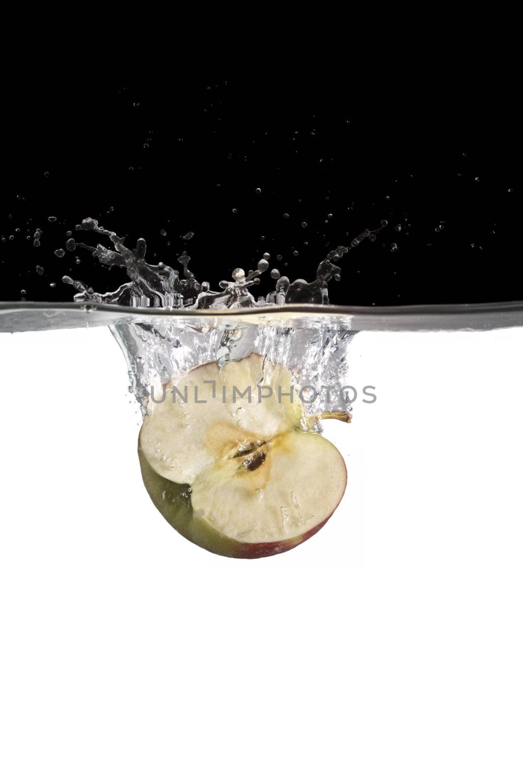 one apple slice in water with black and white background