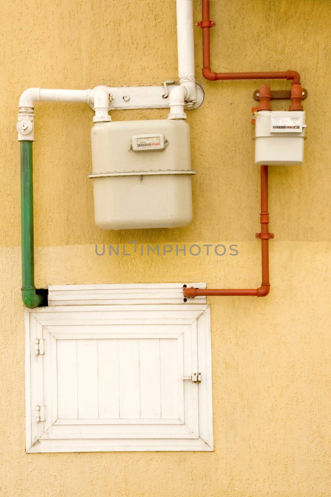 yellow wall with gas pipe and gas counter