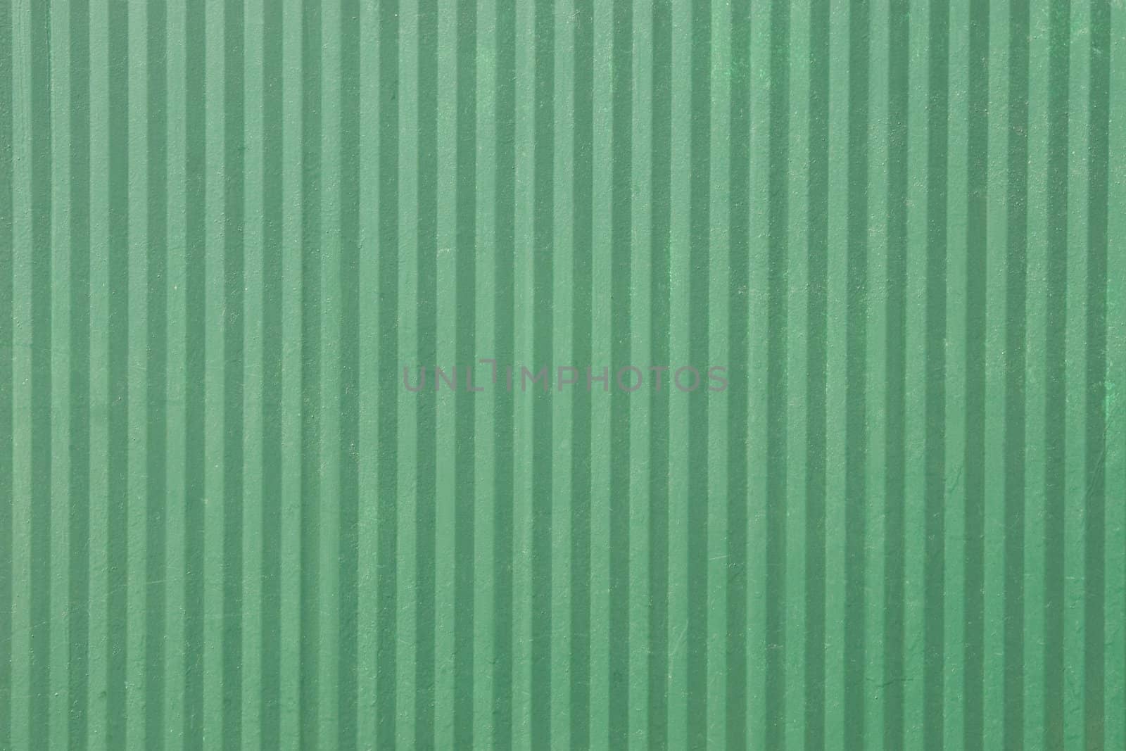 green surface of an old fence with vertical lines