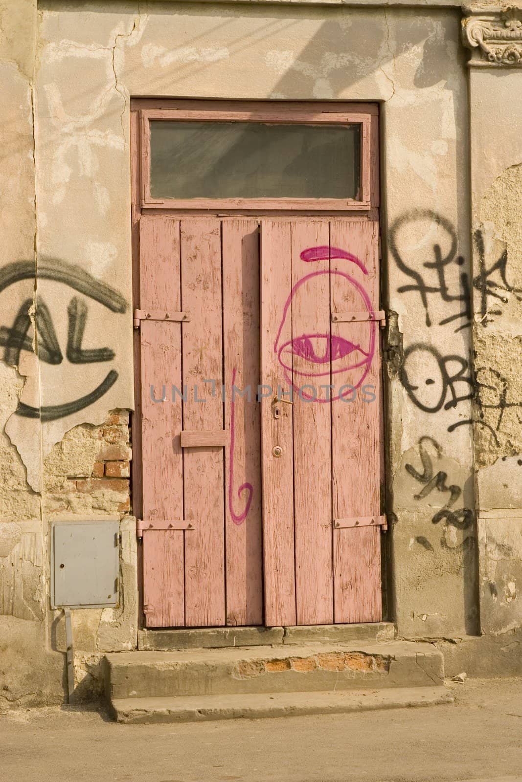 old wooden door with red and black graffiti 