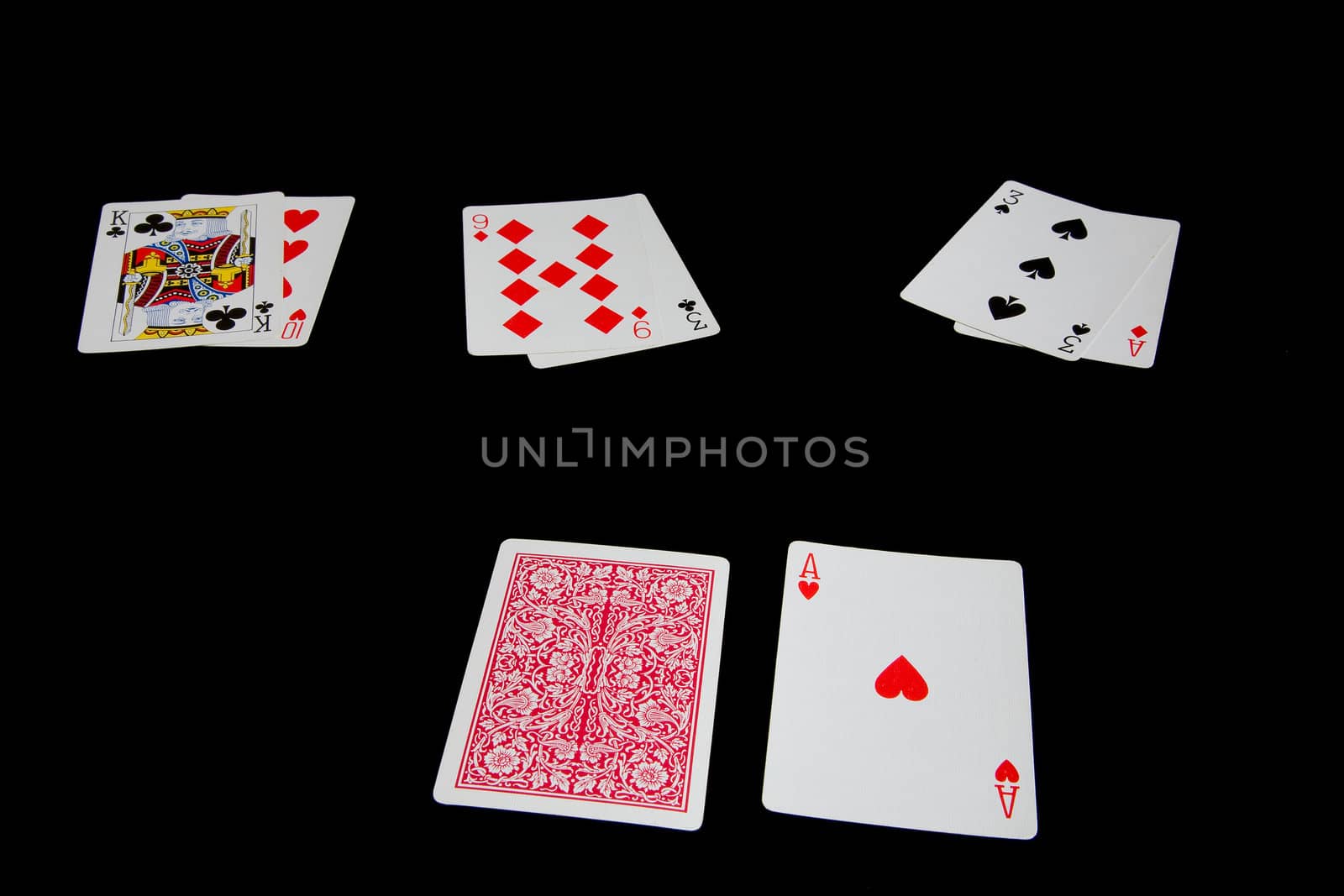 Three blackjack hands stand against the dealer's upturned ace against a black background
