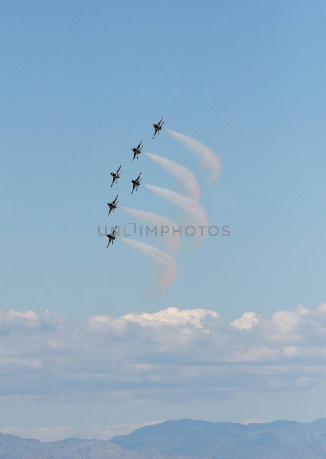 Six fighter jets flying in formation against a clear blue sky