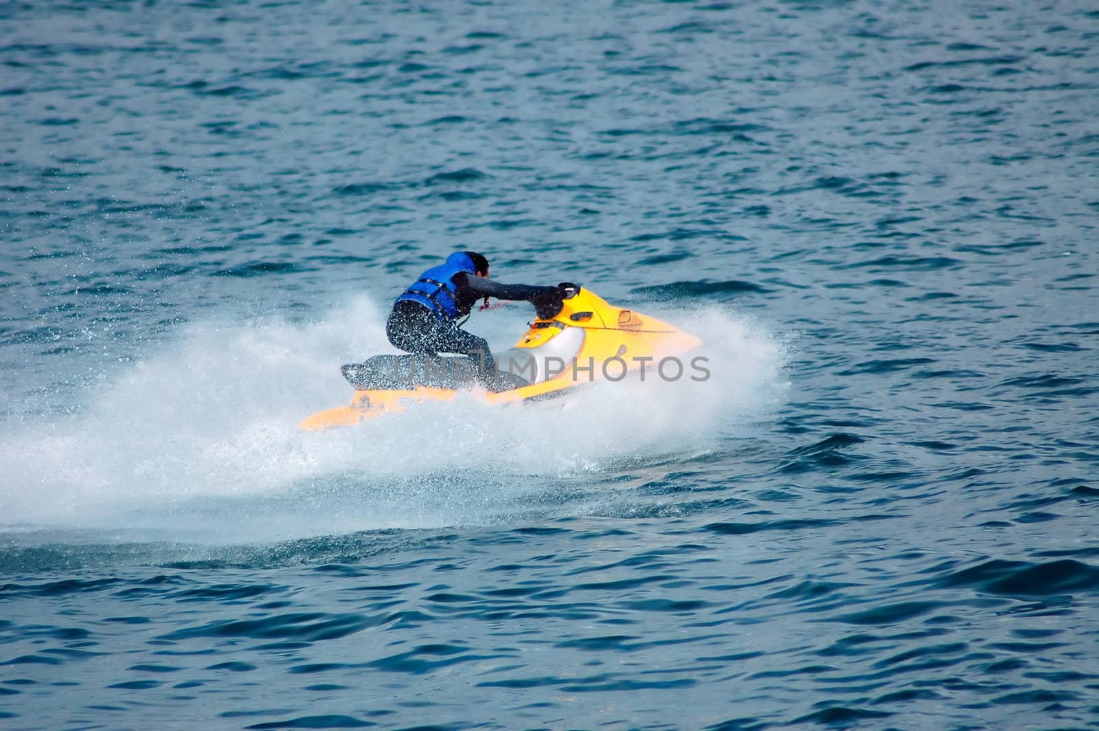 Yellow jet-ski on a blue sea