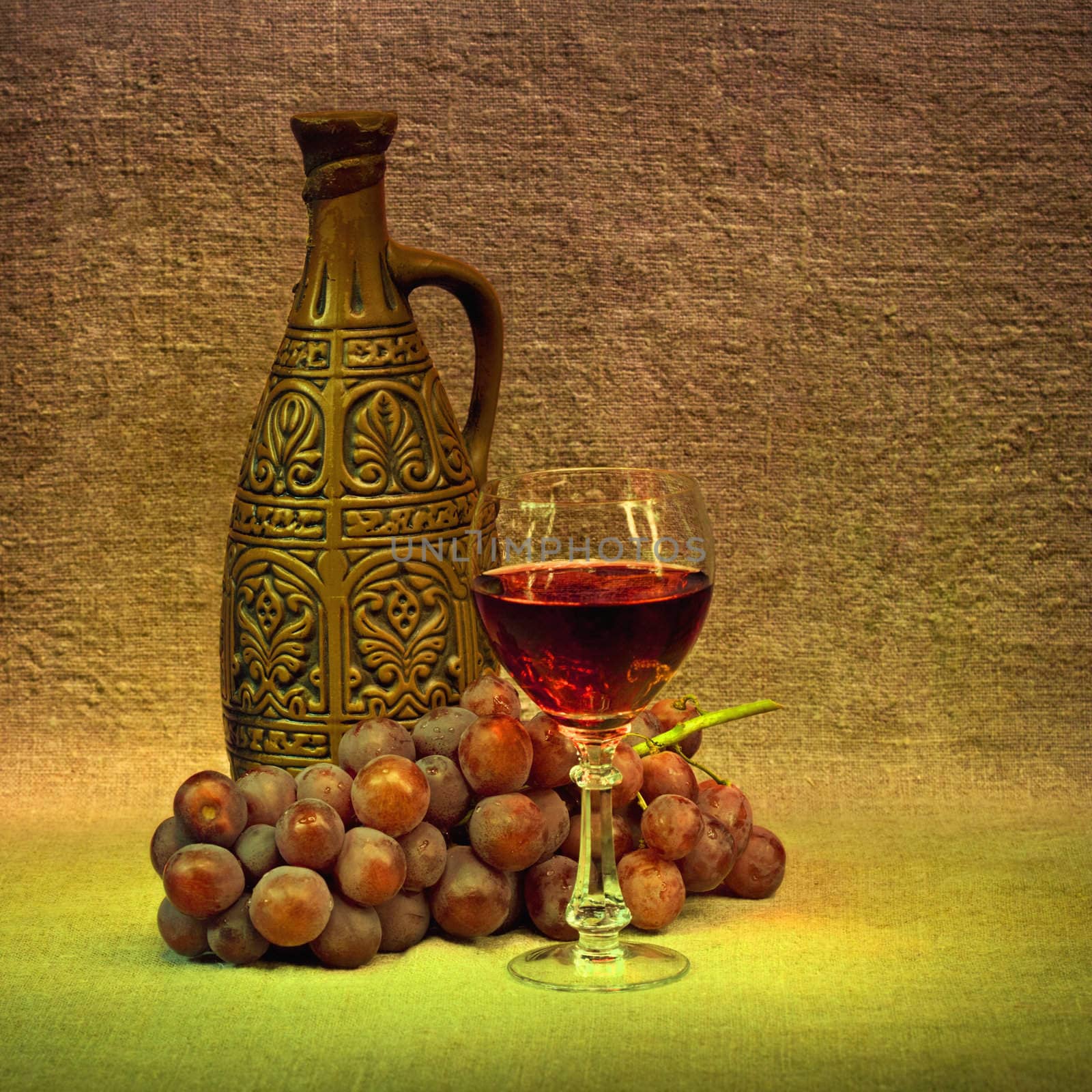 Clay bottle, glass and grapes