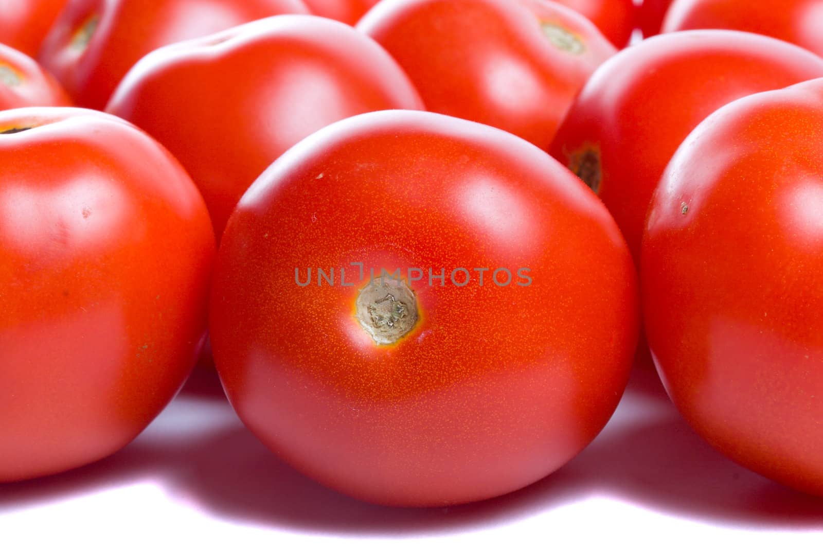 close-up many ripe tomatoes, isolated on white