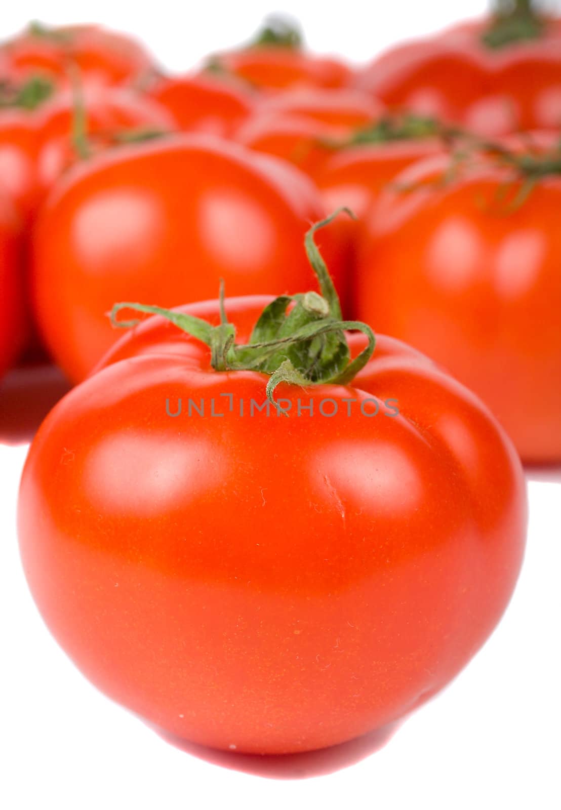 close-up ripe tomato on tomatoes background, isolated on white