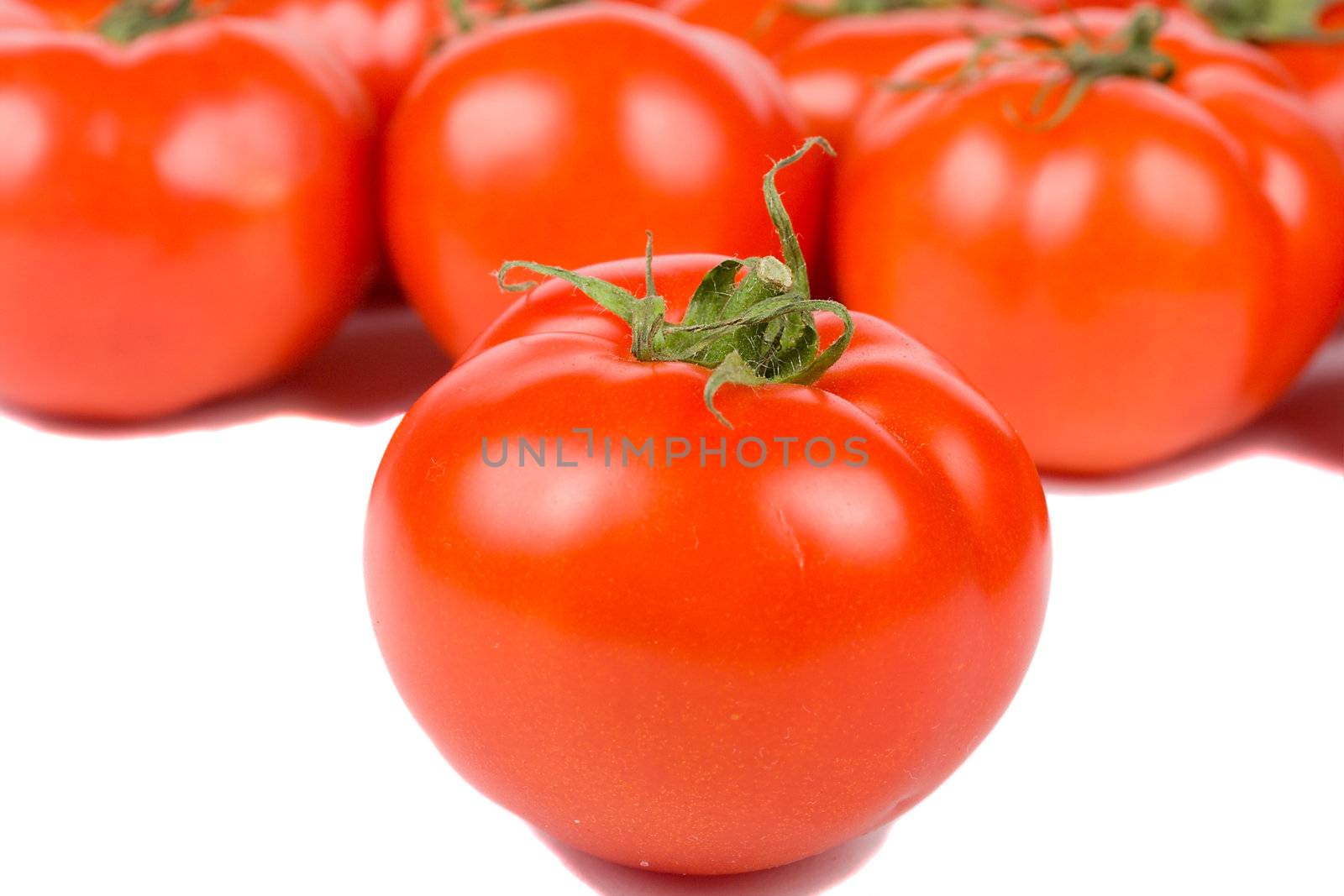 close-up tomato on tomatoes background, isolated on white