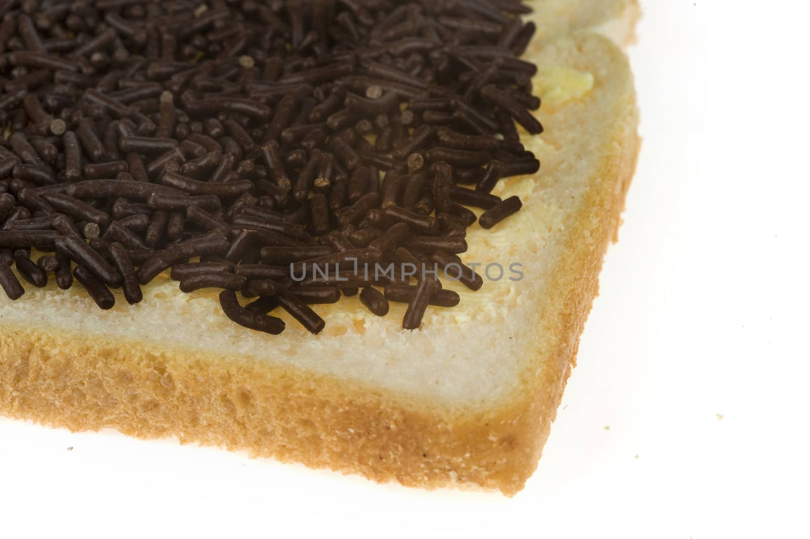 a closeup of a slice of bread with butter and sprinkles