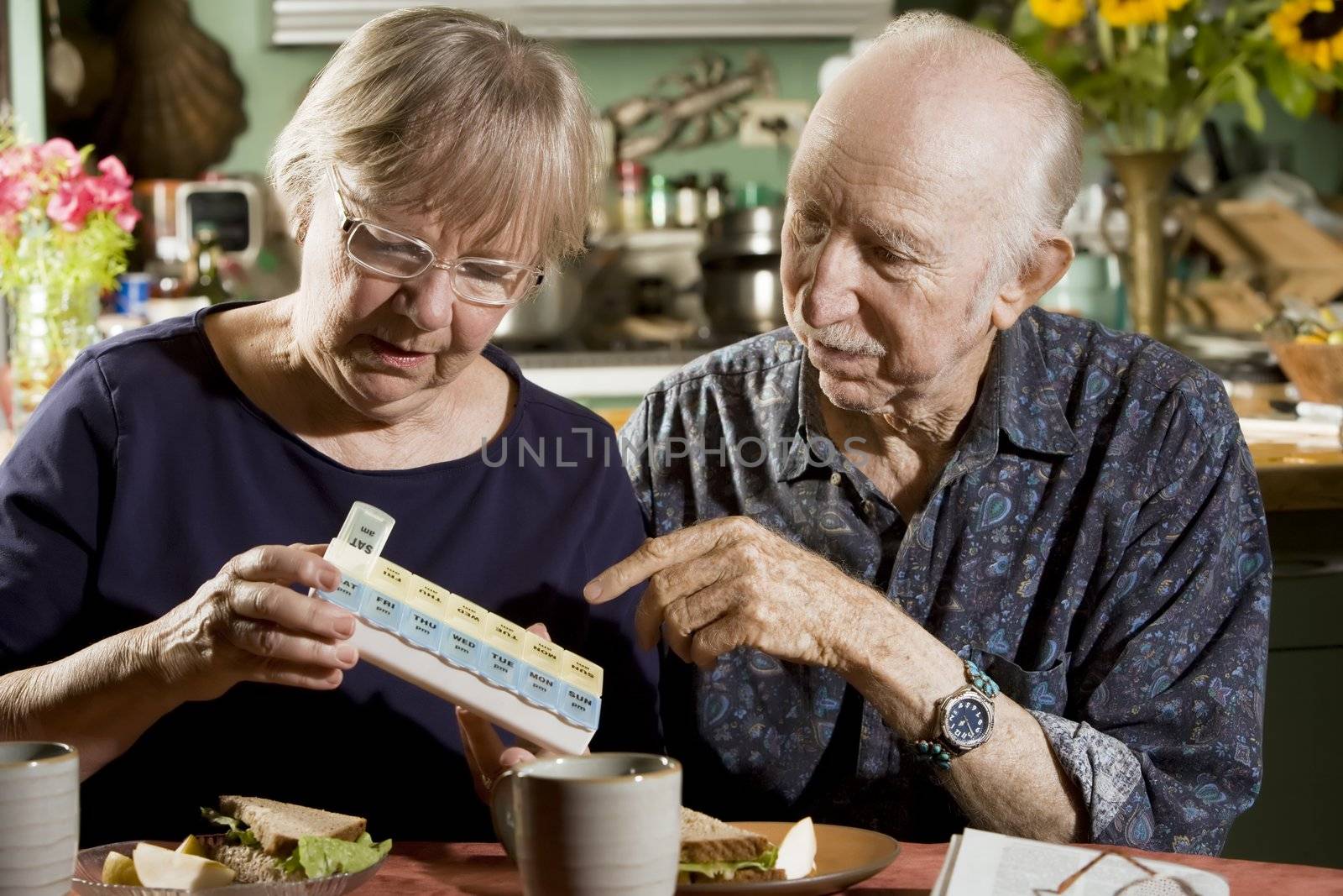 Portrait of Senior Couple Discussing Medications 