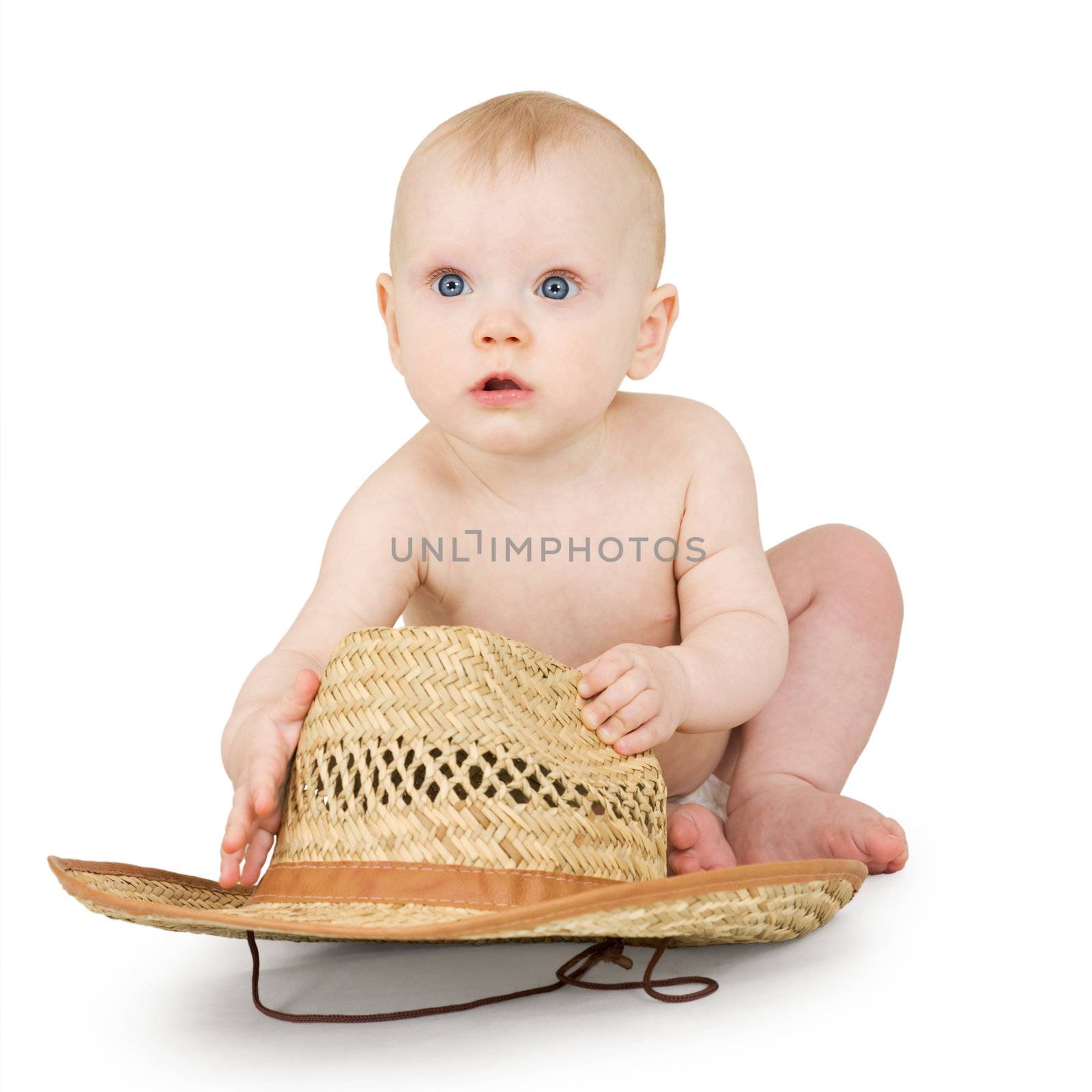 An infant with a straw cowboy hat on a white background