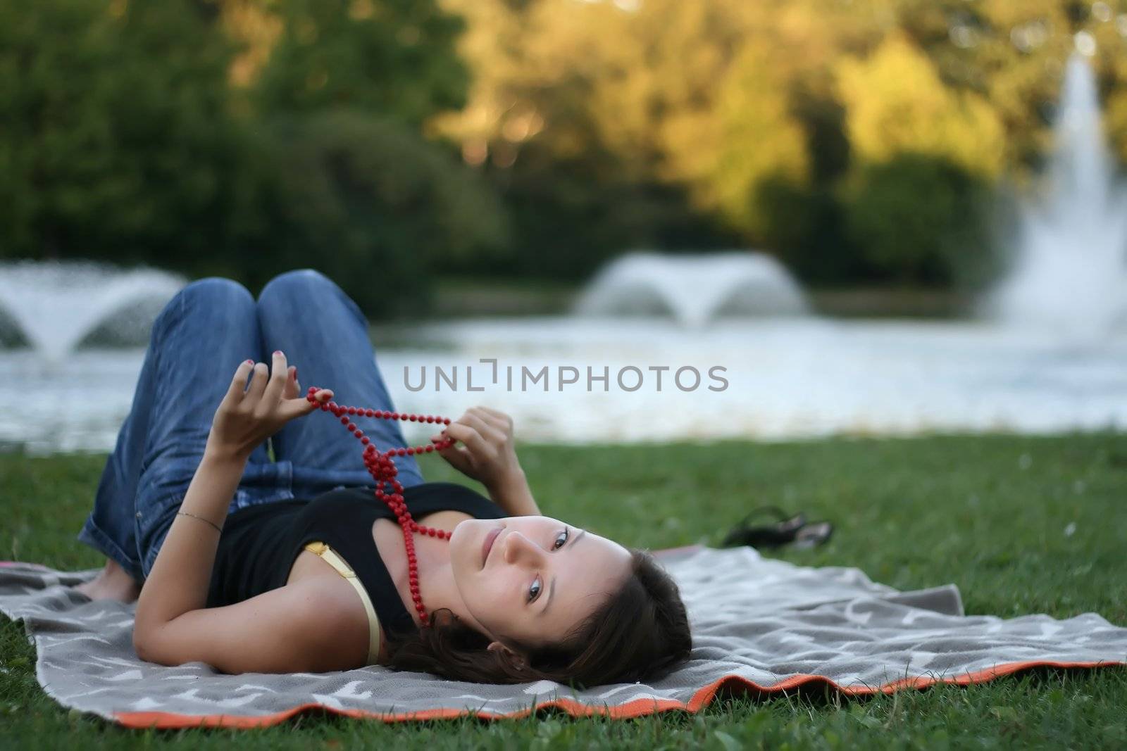 Young woman relaxing near the pond