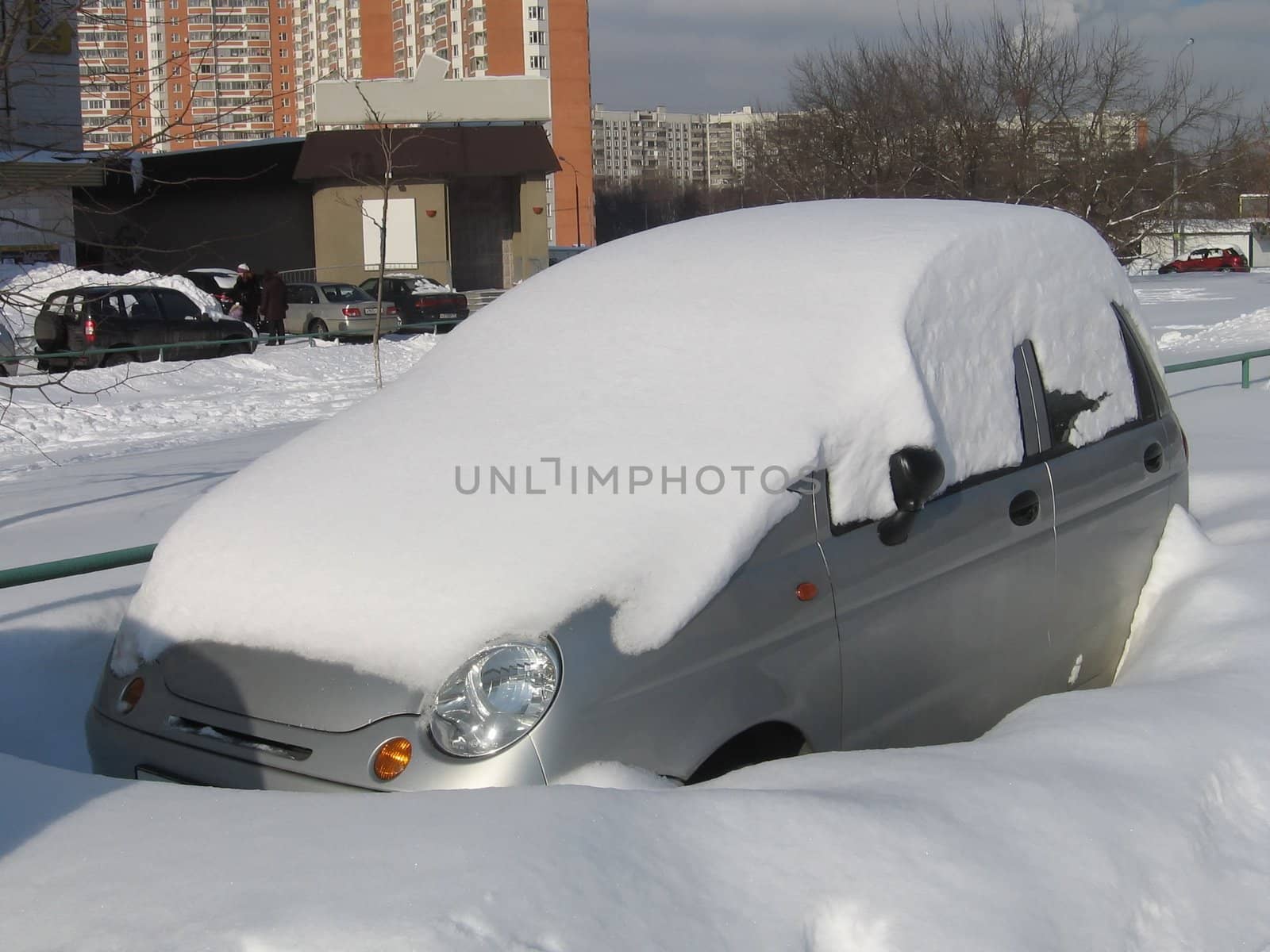 Little car with a pile of snow on the top