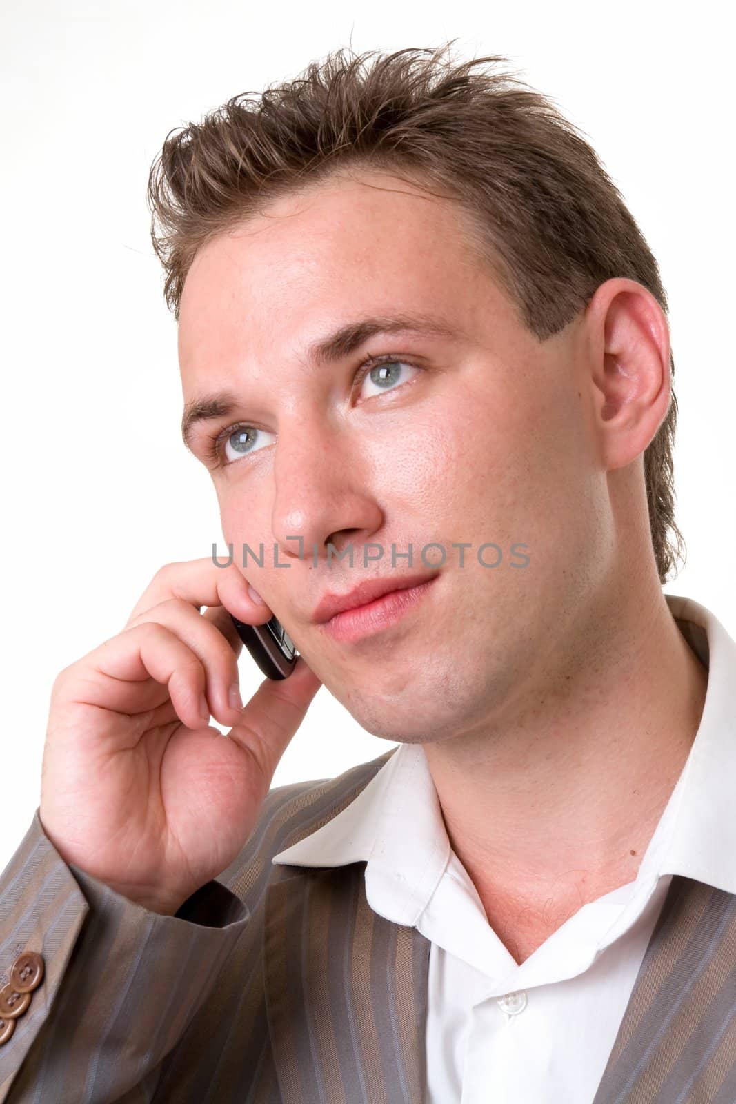 Young man with mobile phone on a white background.