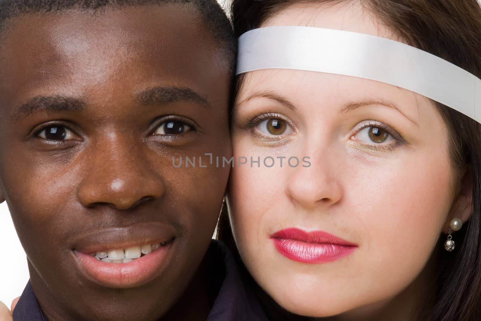 Two faces close up. Black man and white woman.