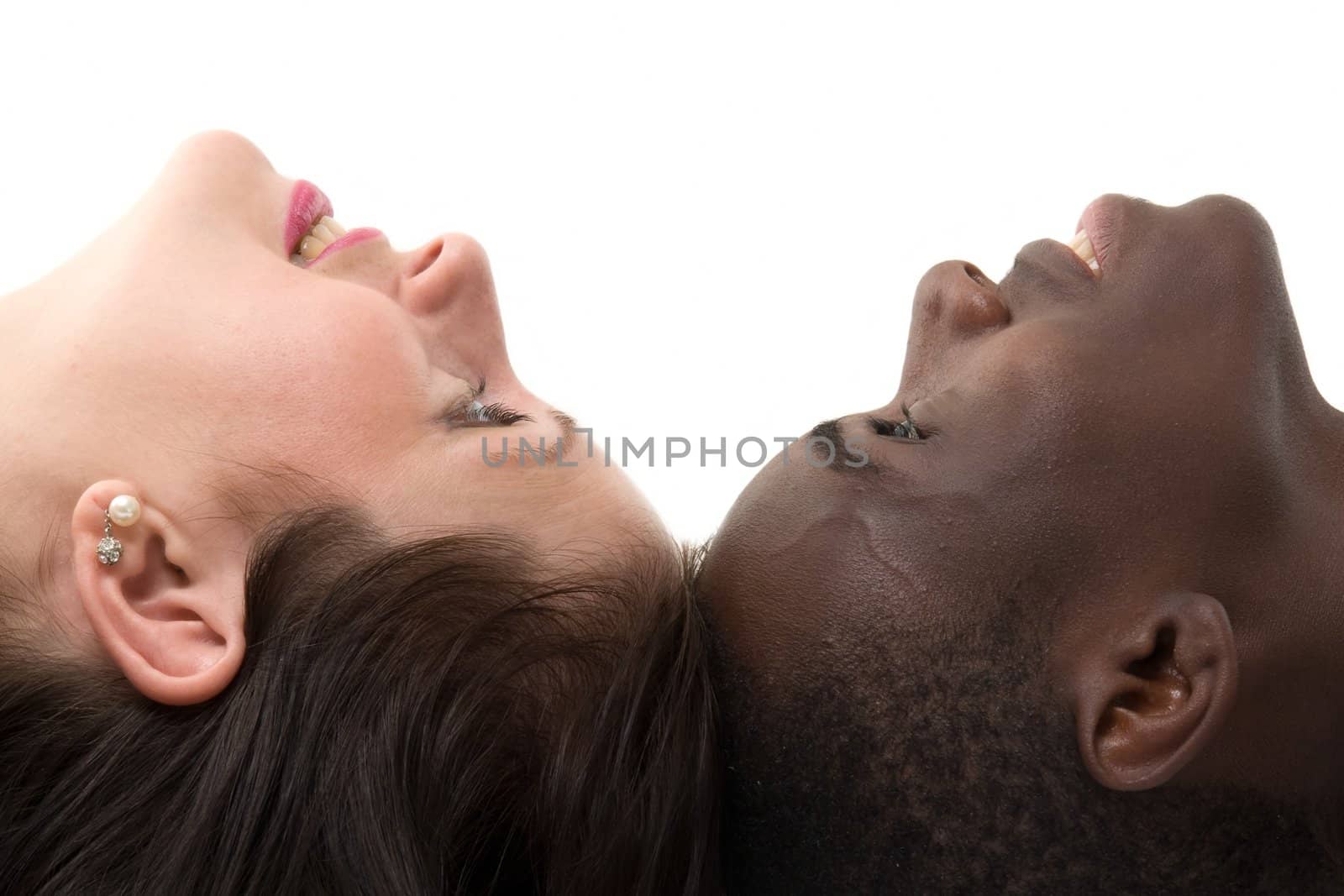 Two faces close up. Black man and white woman on a white background.