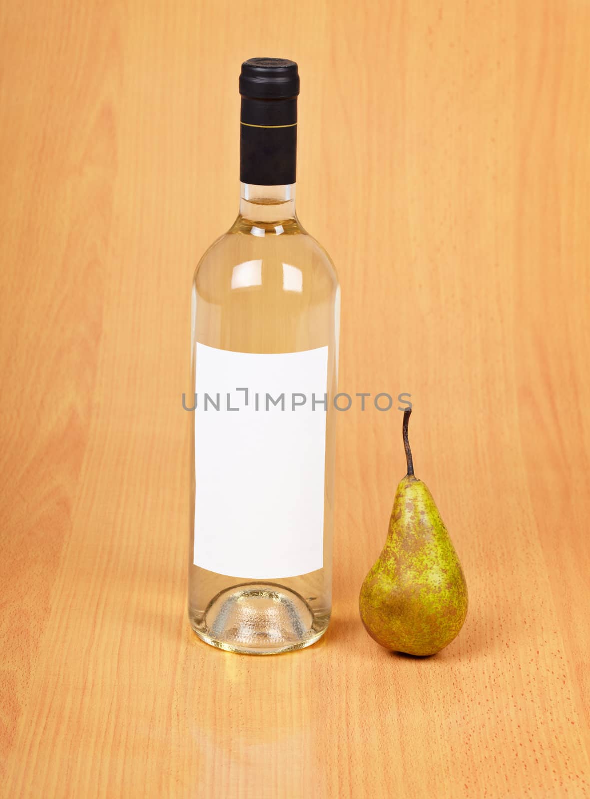 A bottle of pear wine on a wooden background