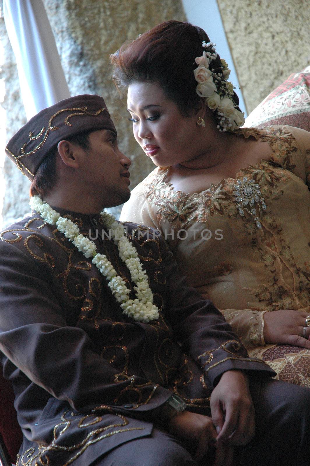 bride and groom wearing traditional costume from west java-indonesia