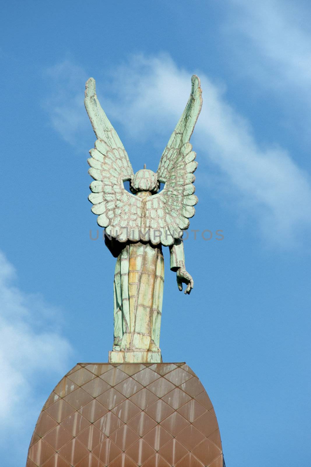 Back of an angel copper statue from the roof of Notre Dame de Bonsecours Chapel overlooking the old port of Montreal