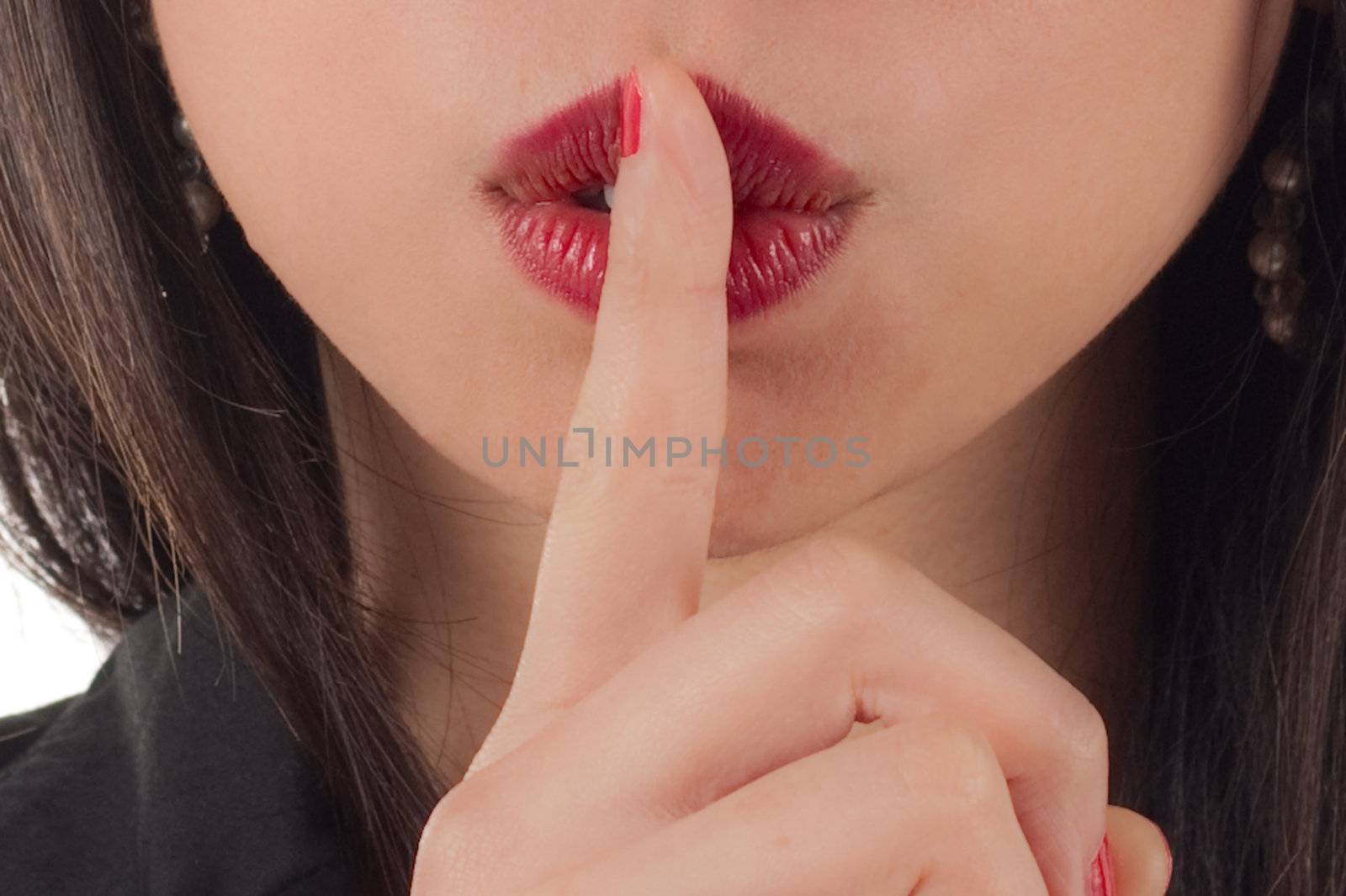 Shhh - Studio shot of beautiful sexy young woman with finger to lips