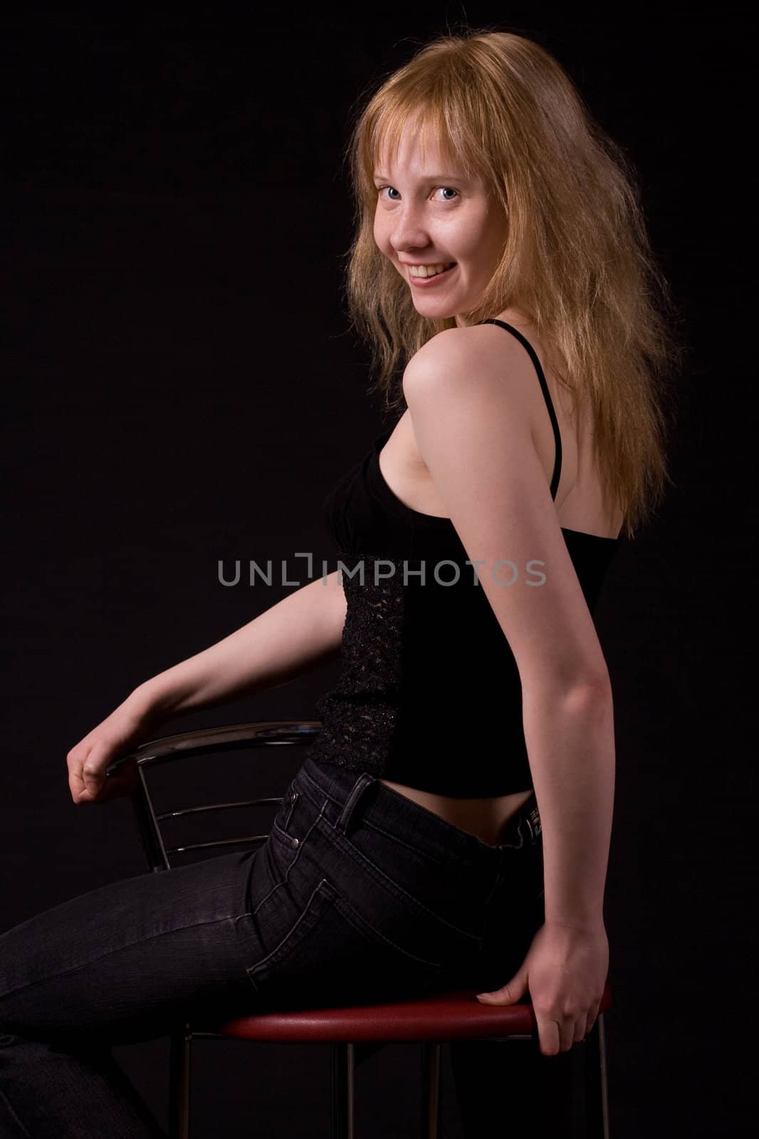 sitting blonde girl on black
