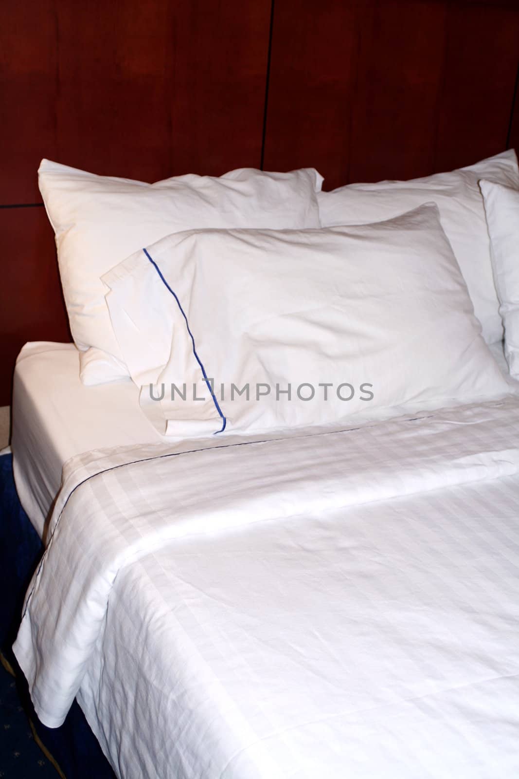 A hotel bed with clean, white linens