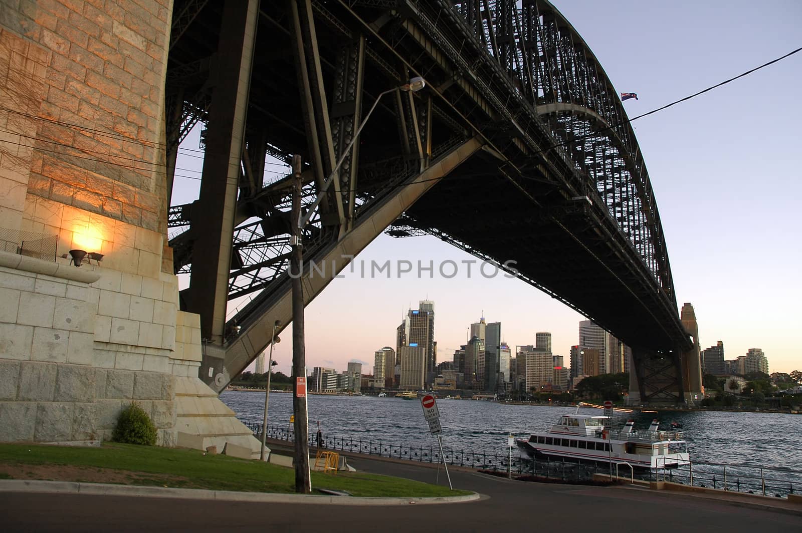 ferry under Harbour Bridge in Sydney, CBD in background