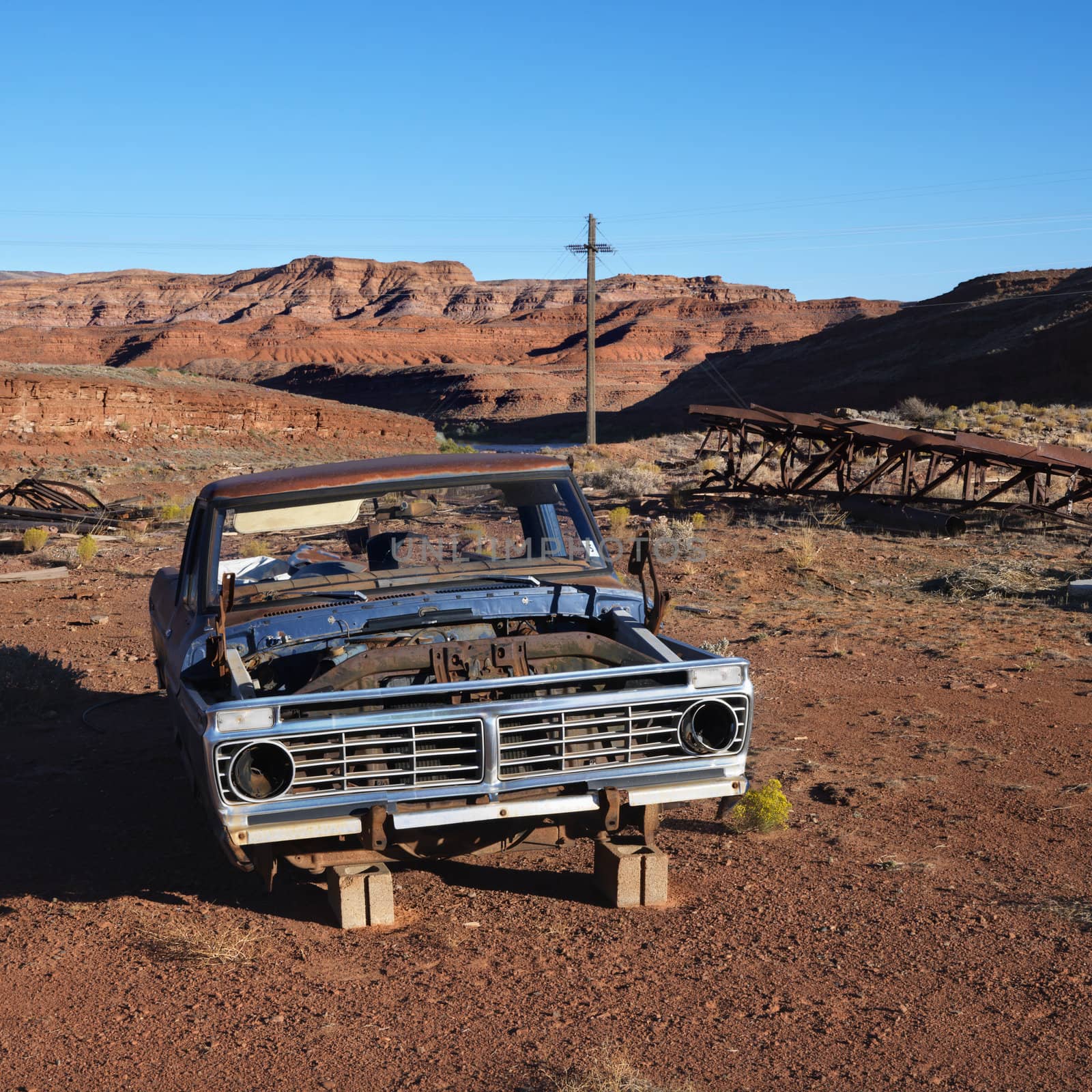 Old abandoned junk car in the desert.