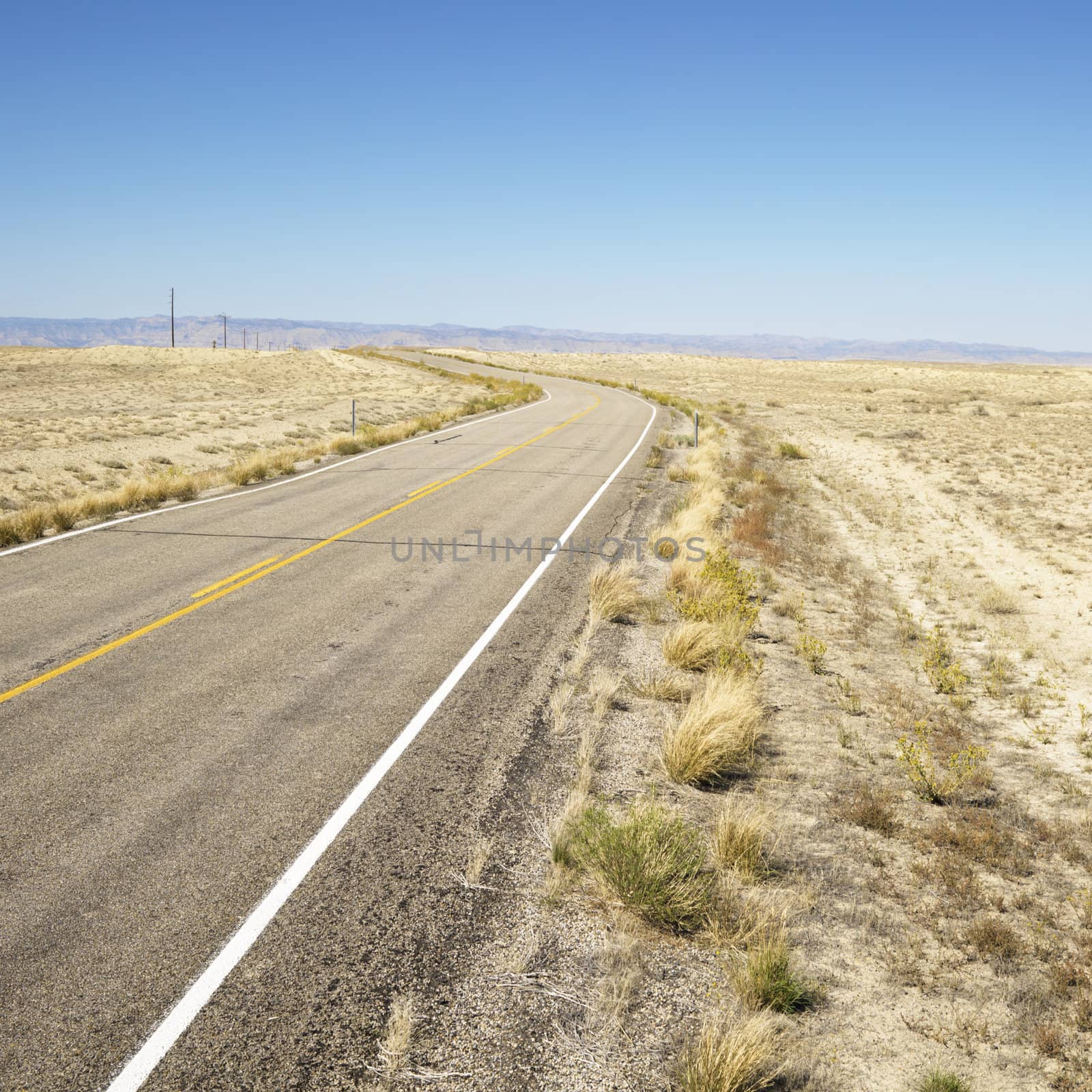 Road through barren landscape in Utah.