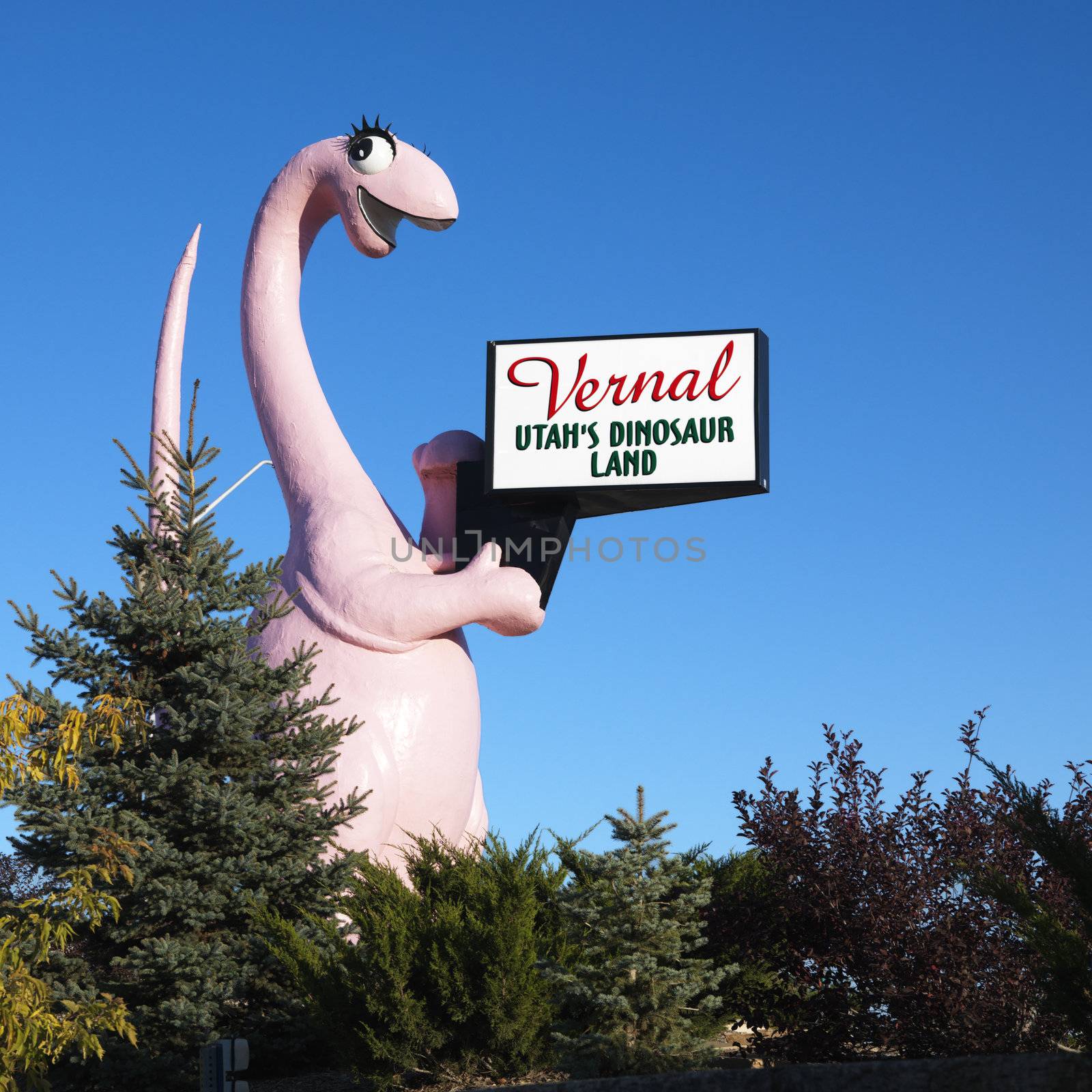 Pink dinosaur holding sign for city of Vernal, Utah.