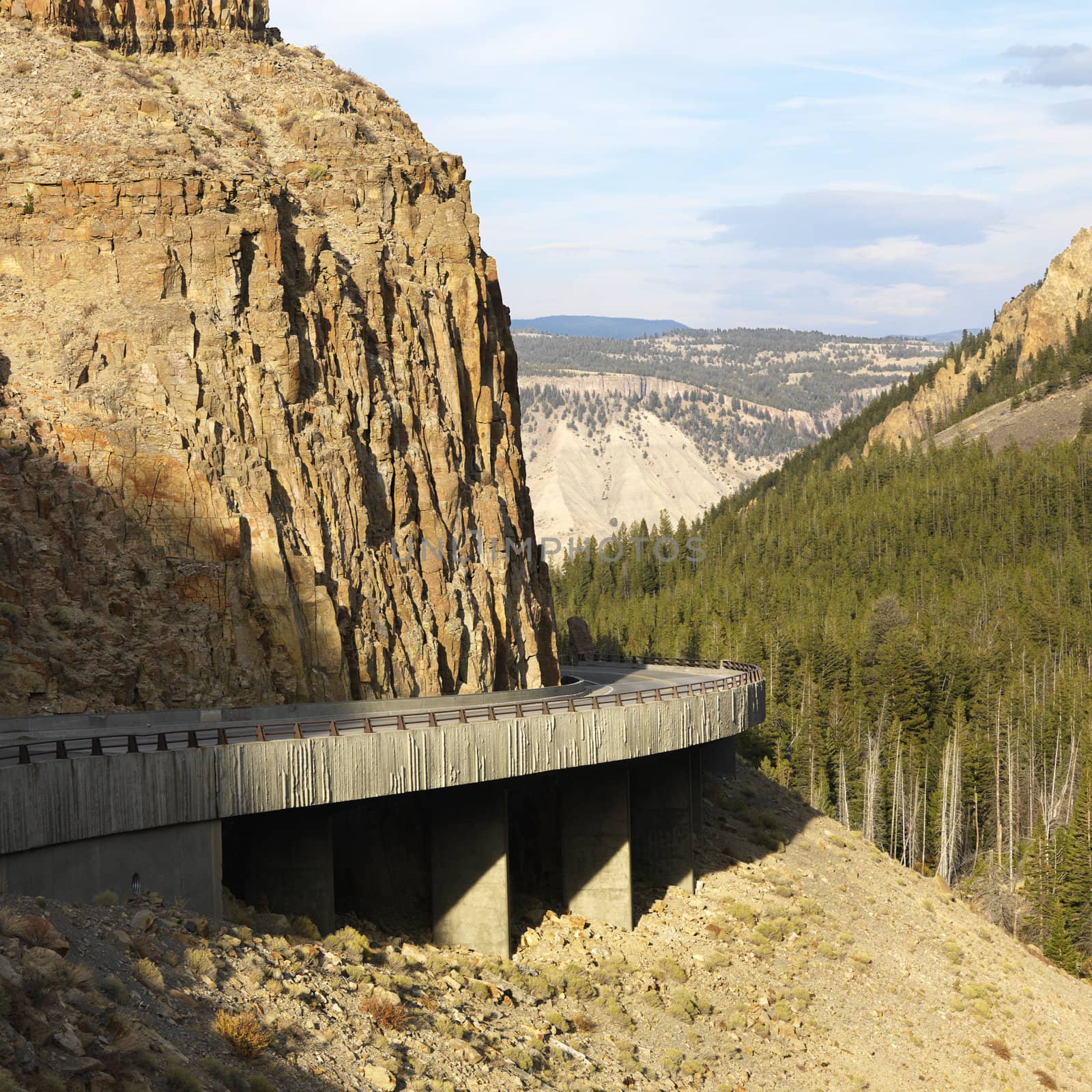 Highway winding through steep Wyoming mountains.