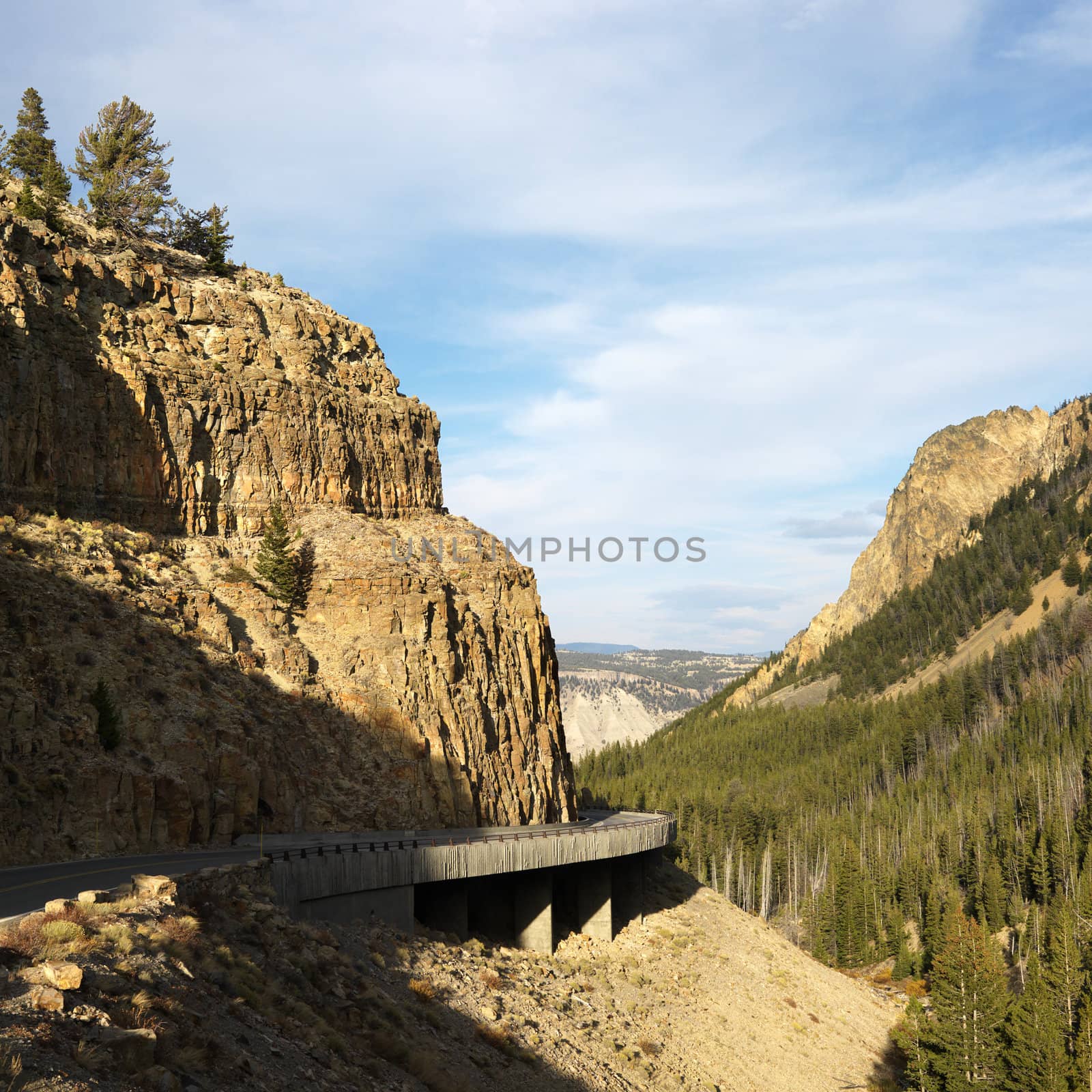 Highway winding through steep Wyoming mountains.