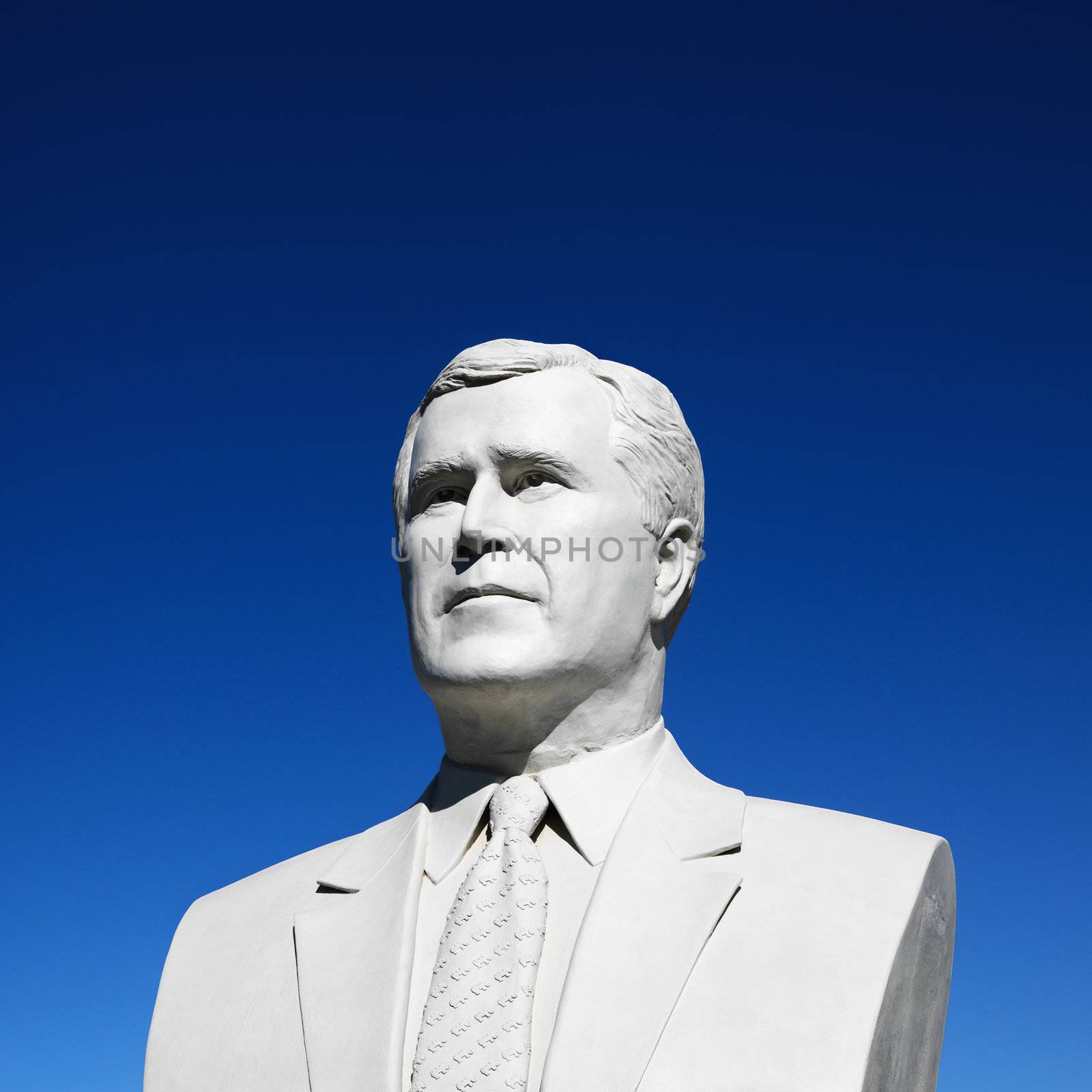 Bust of George Bush sculpture against blue sky in President's Park, Black Hills, South Dakota