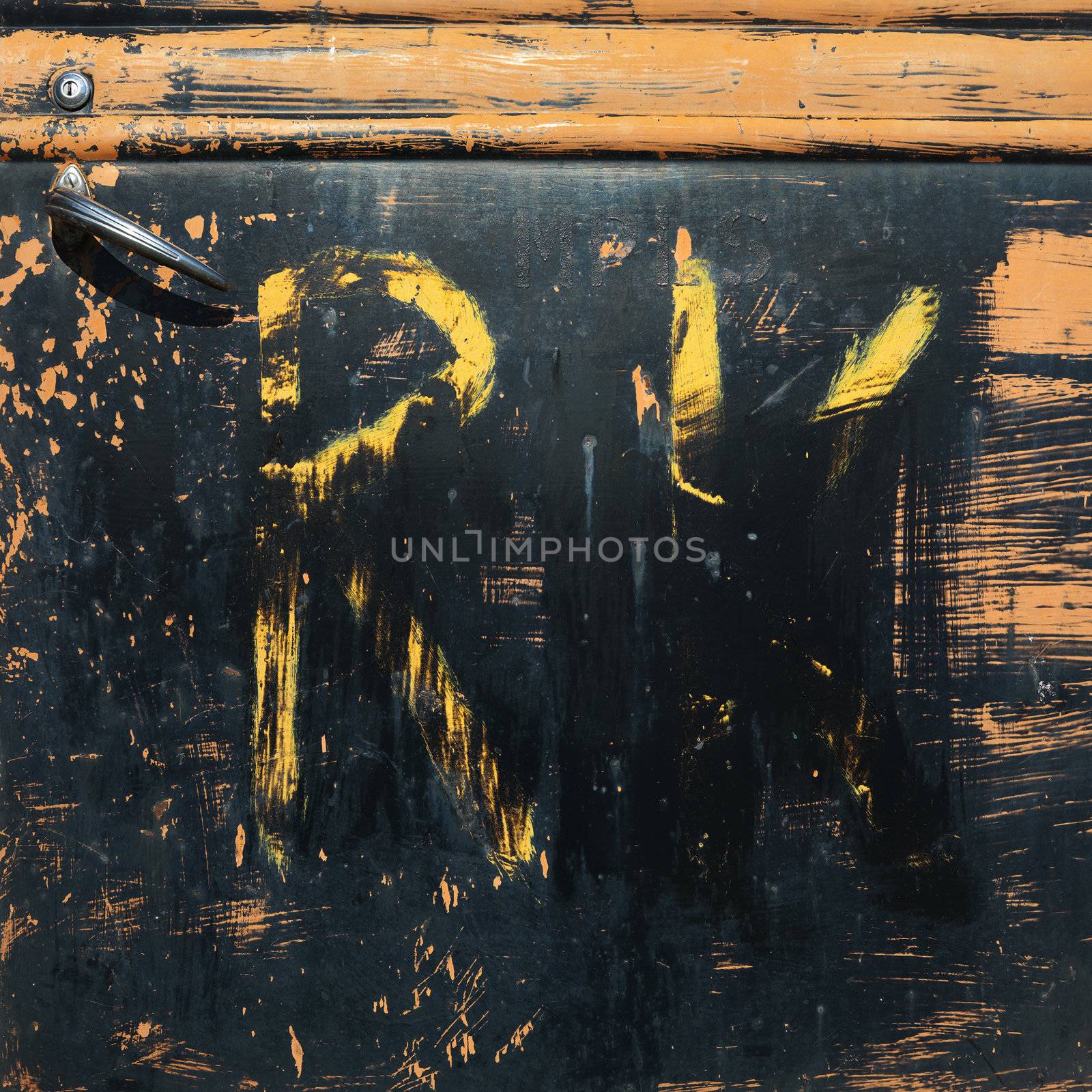 Close-up of scratched up door of old pick-up truck.