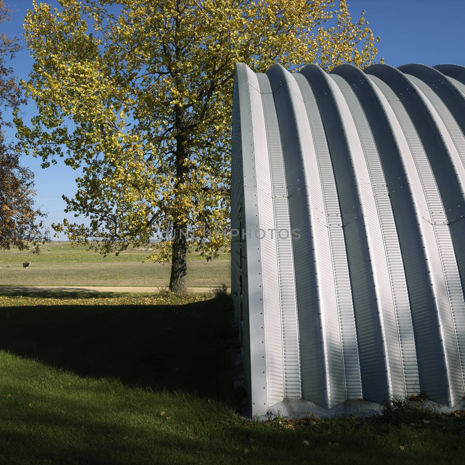 Side view of steel hay storage building on farm.