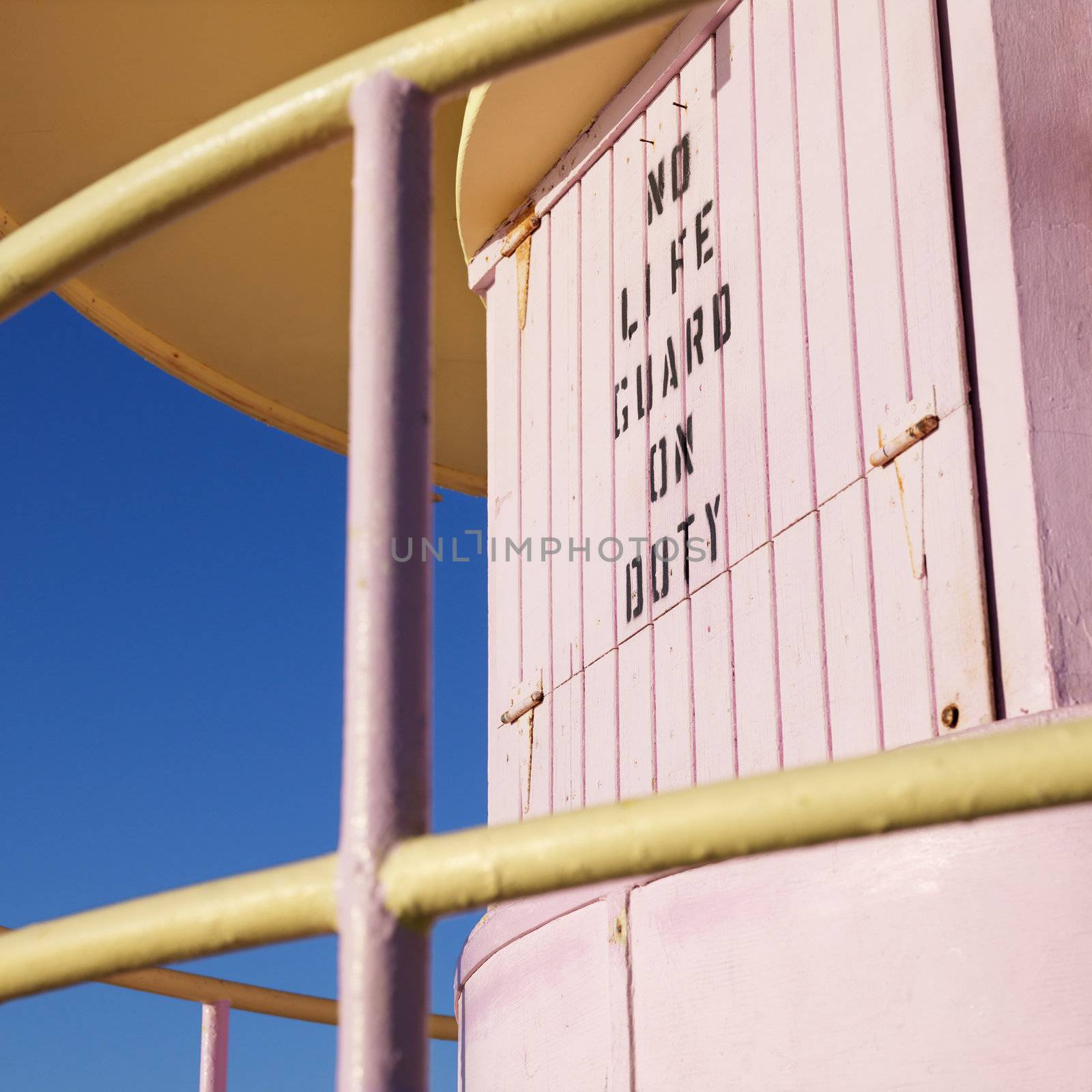 Close-up of pink art deco lifeguard tower with no lifeguard on duty sign in Miami, Florida, USA.