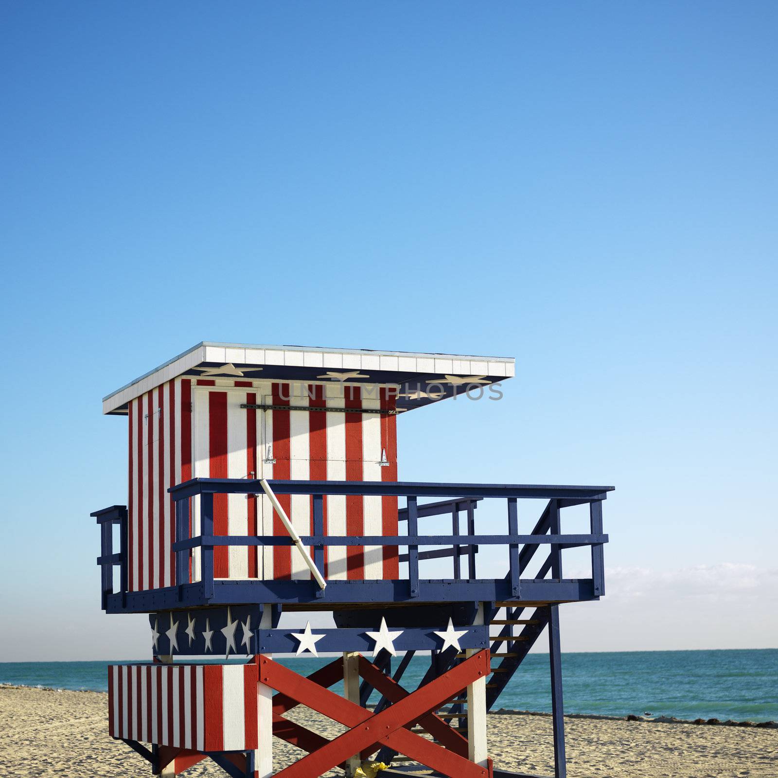 Lifeguard tower painted red, white and blue with stars and stripes on beach in Miami, Florida, USA.