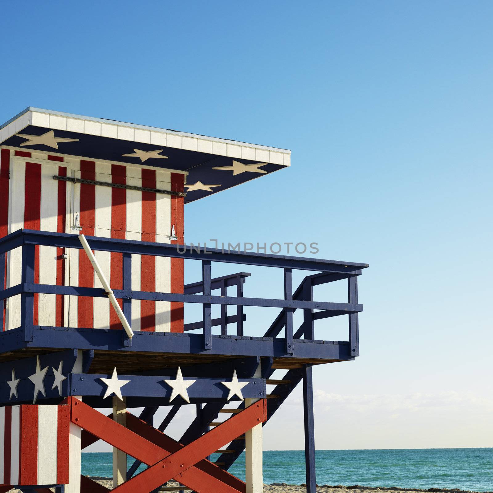 Lifeguard tower painted red, white and blue with stars and stripes on beach in Miami, Florida, USA.