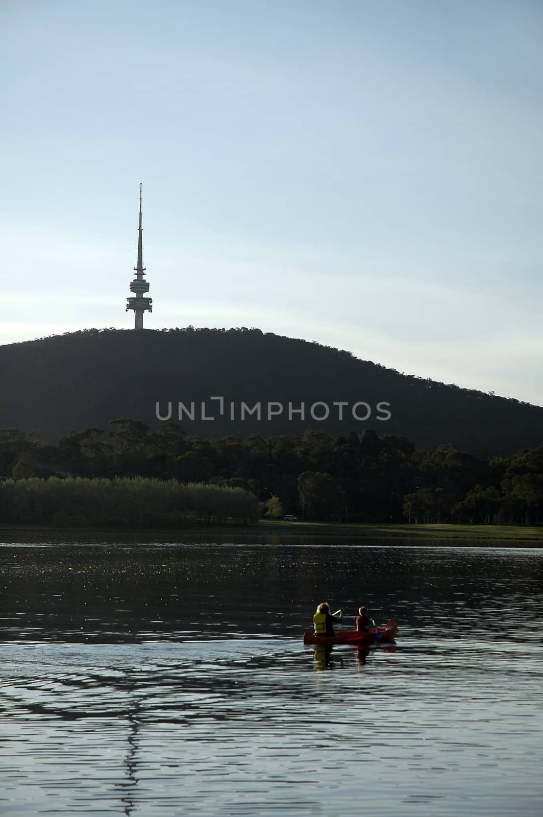 kayak with a woman and a boy, famous Telstra tower in background; Canberra - Australia