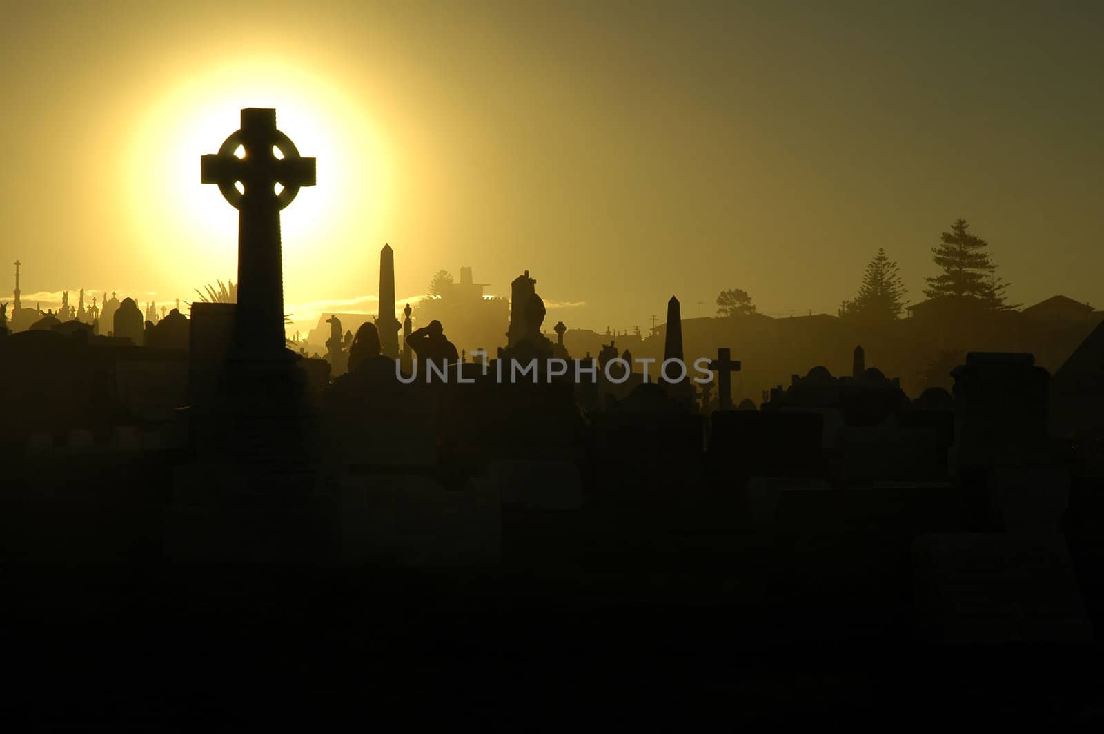 graves silhouettes, yellow sky, two mourning people