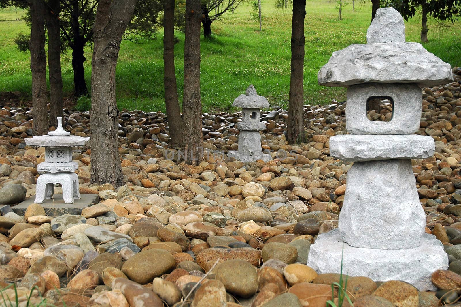 three small buddhist sculptures made of stone