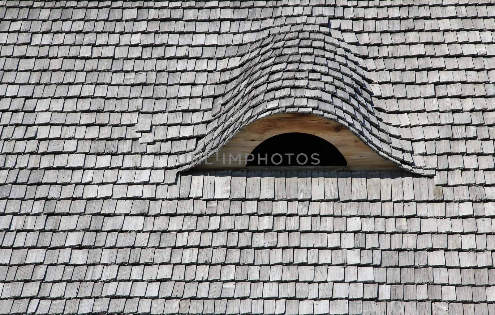 Wood roof and attic window.