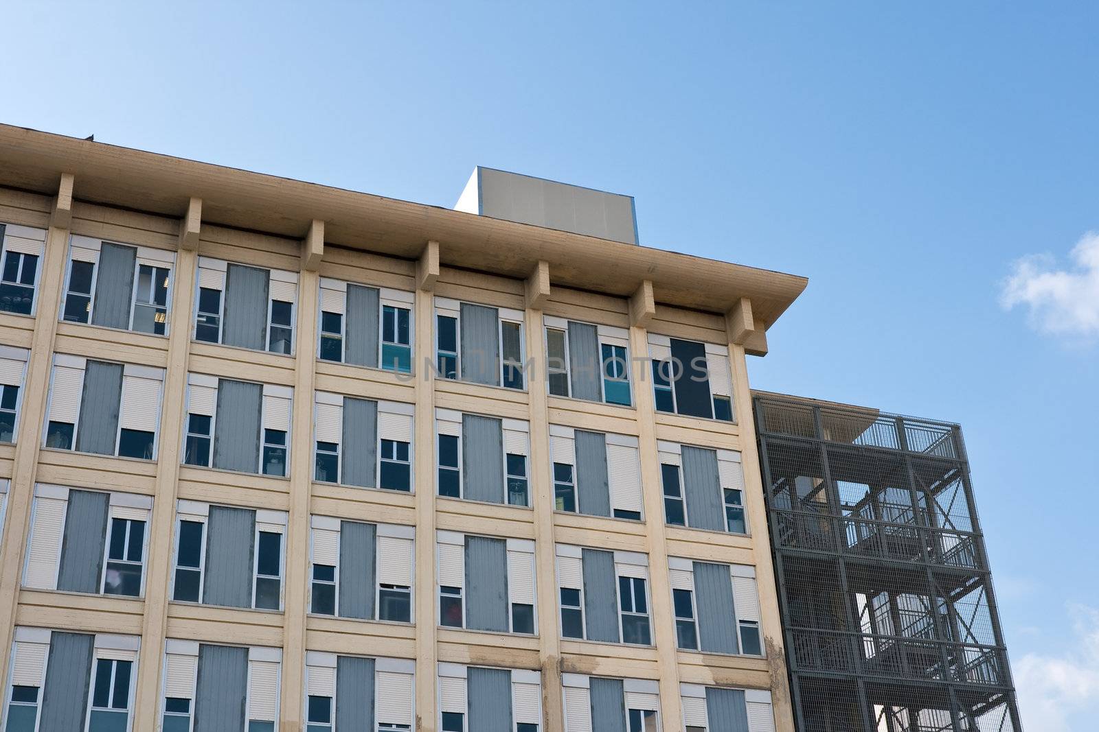 exterior of a modern hospital complex under a blue sky