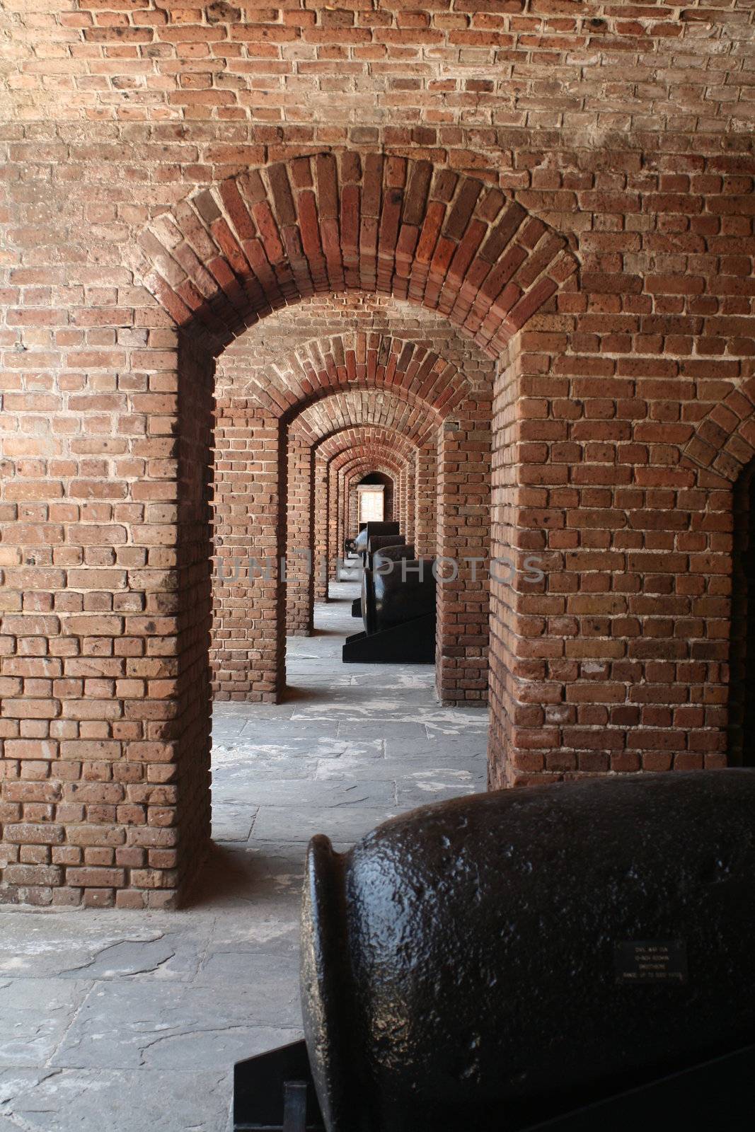 Looking through a series of repeating brick archways.