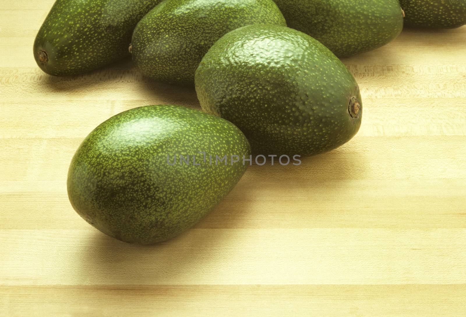 Avocados on a cutting board by Balefire9