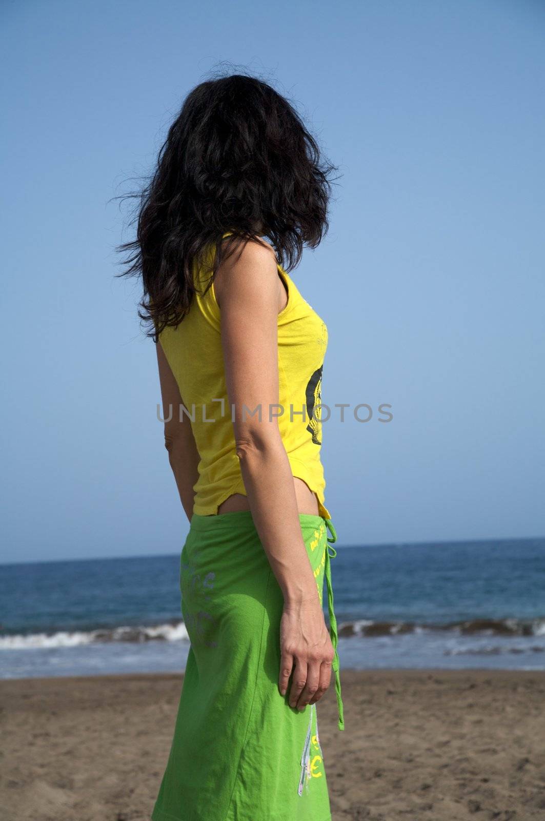 side view of a woman watching the ocean