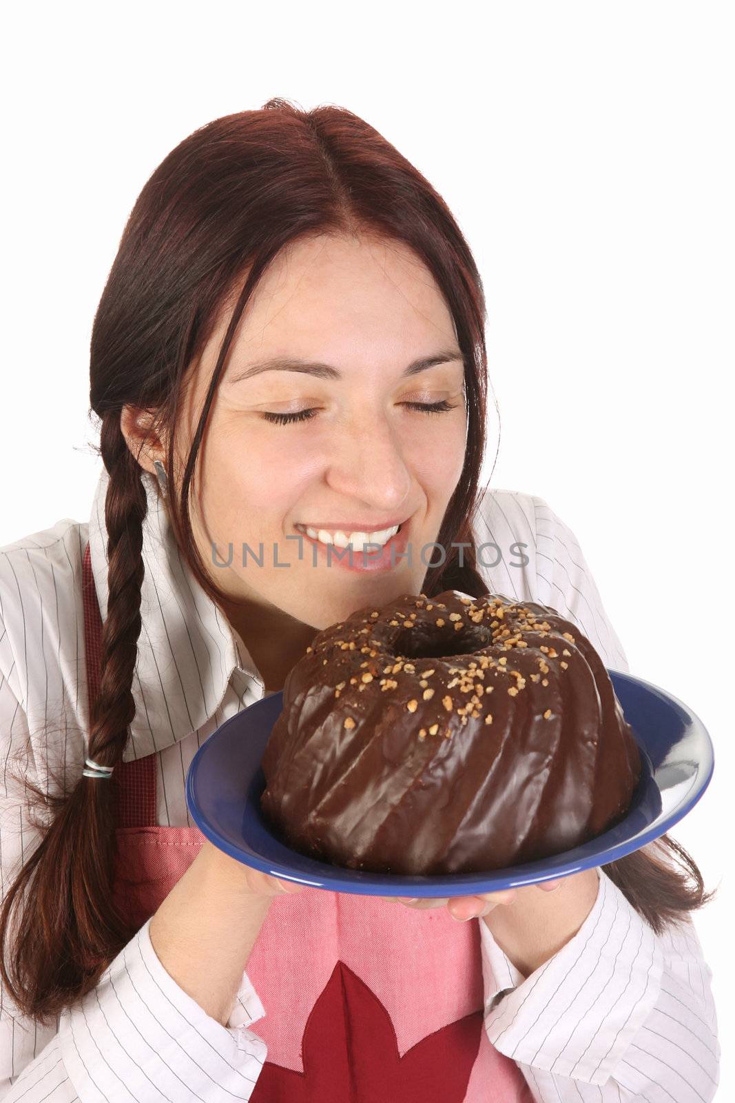 beautiful housewife smelling bundt cake on white background