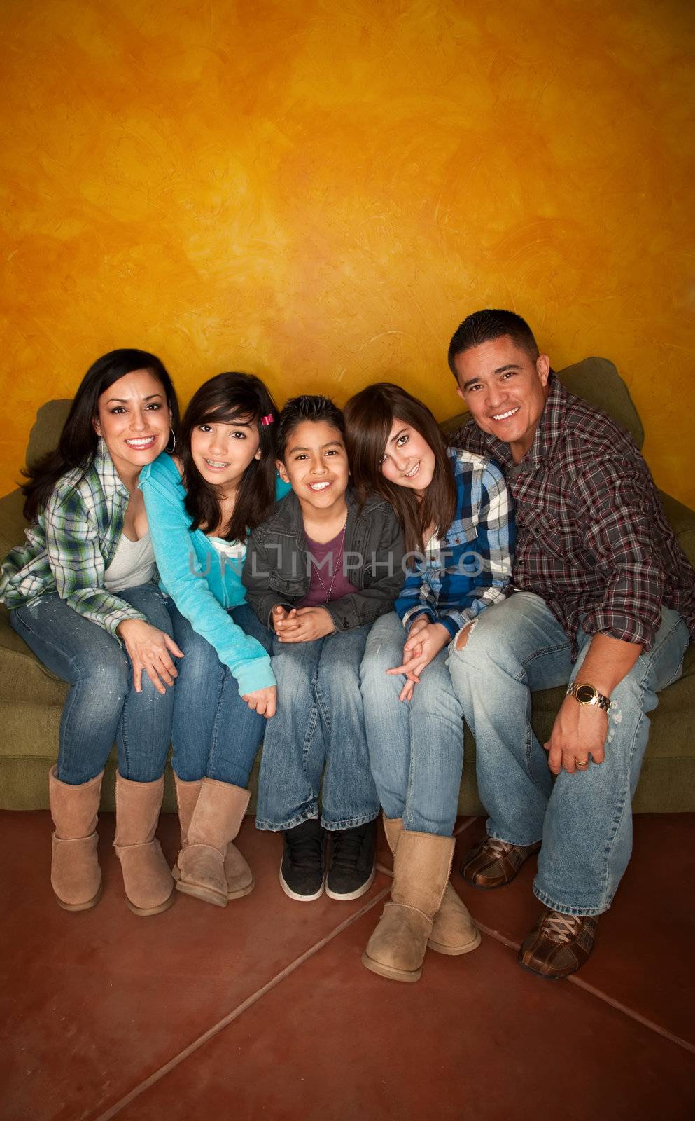 Attractive Hispanic Family Sitting on a Green Couch