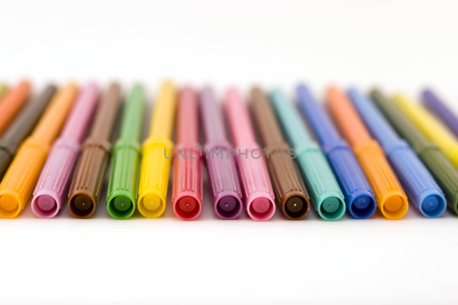 front view of row of colorful markers with shallow dof