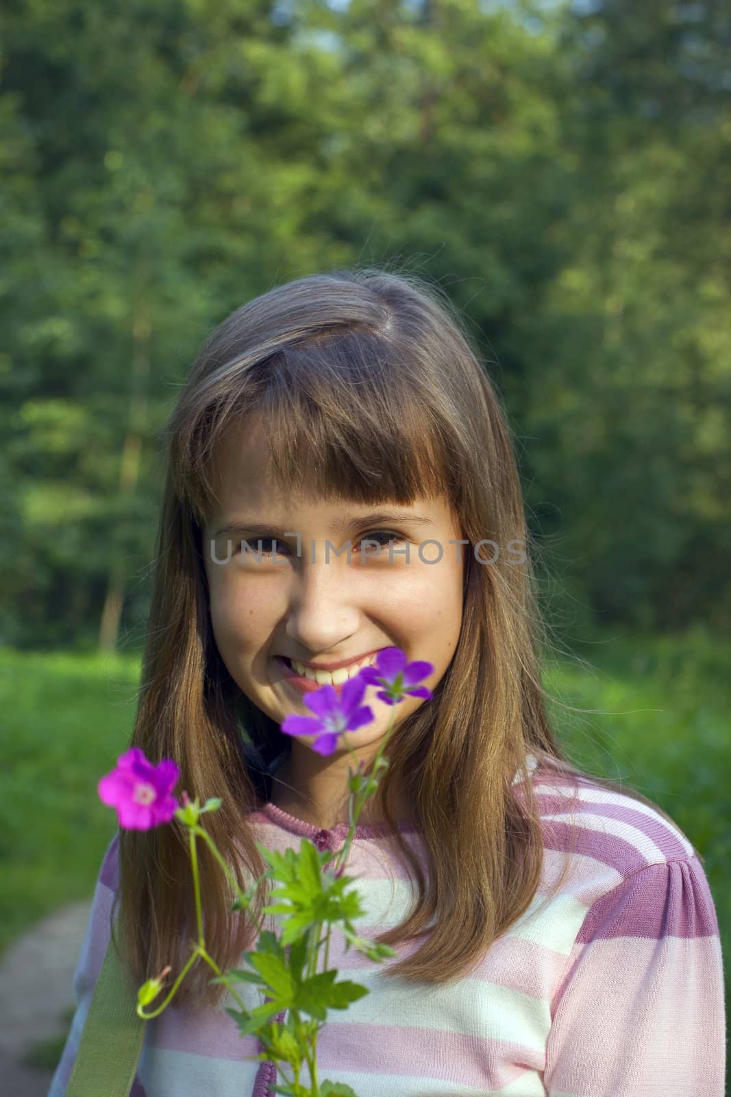 Portrait of girl with flower in summer time.