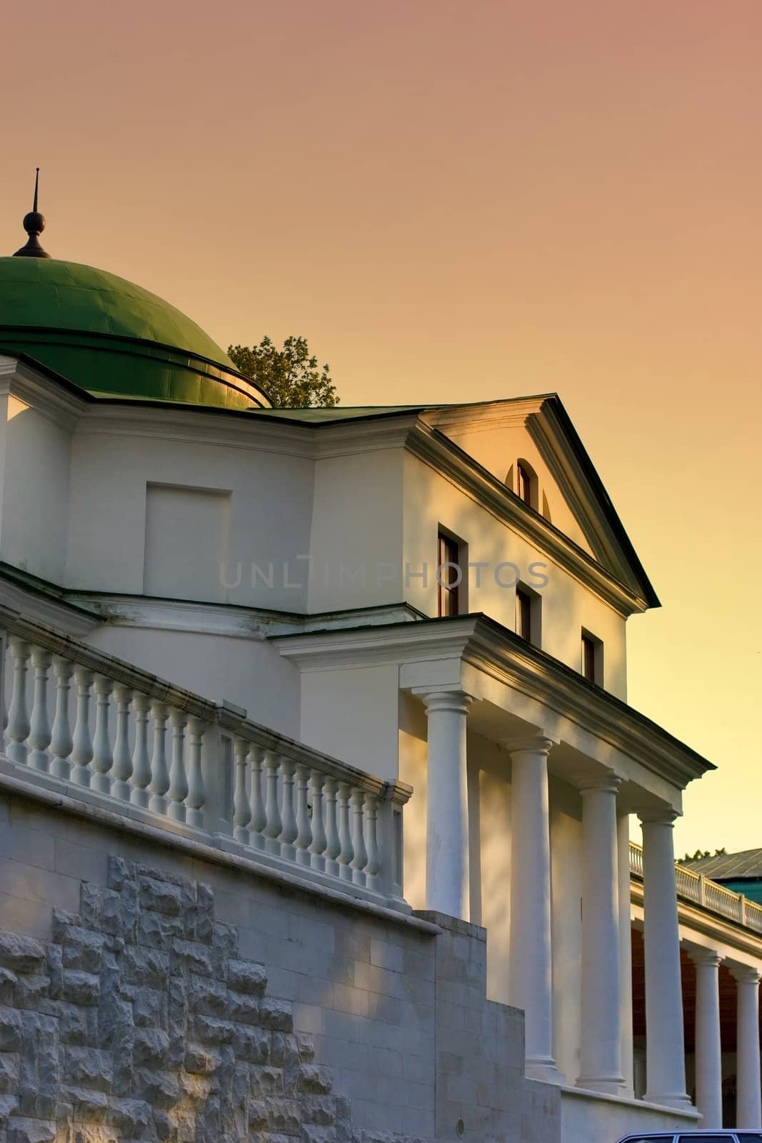 Old building with columns after reconstruction at evening.